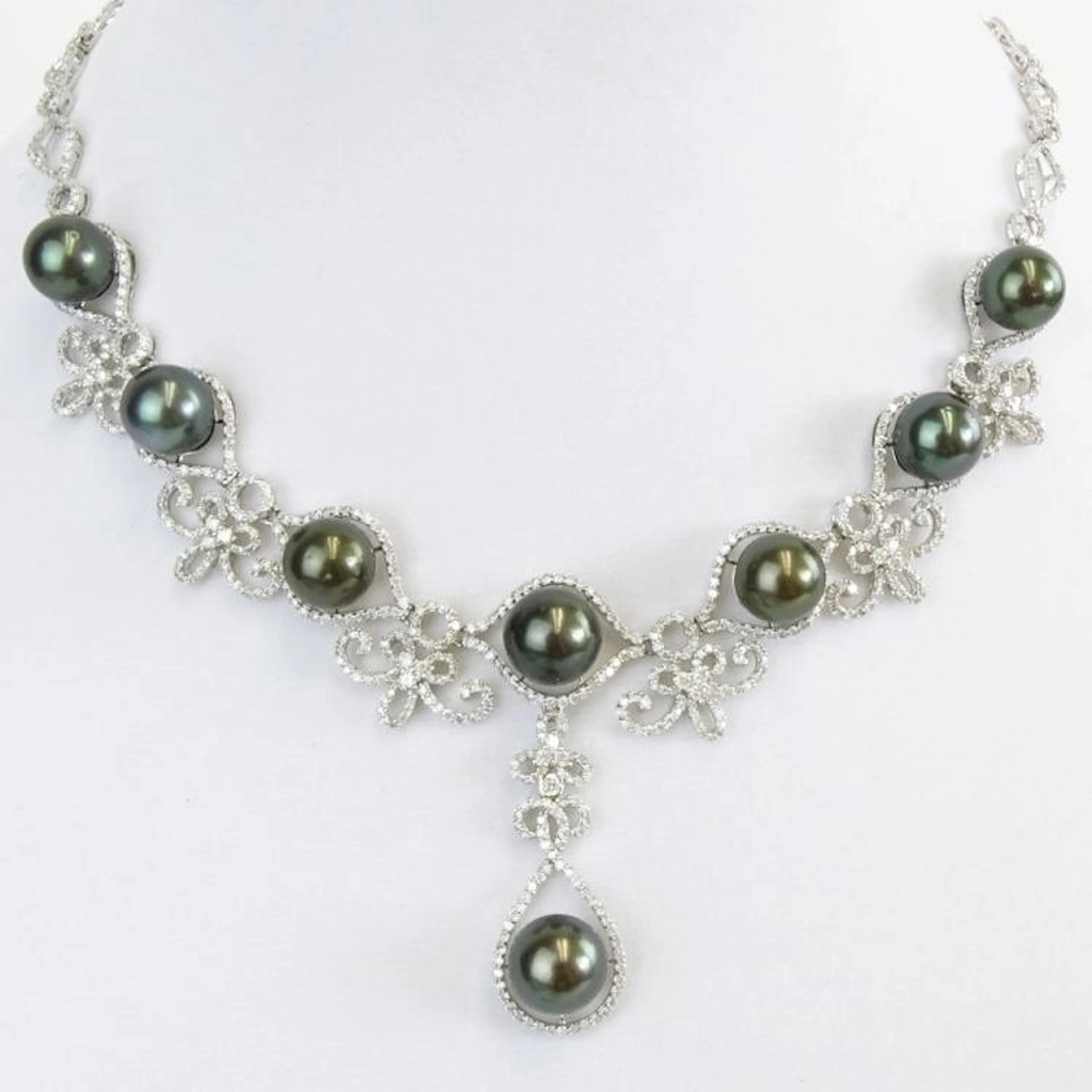 AIG Certified Eight (8) Tahitian Black Pearl, 10.68 Carat Round Brilliant Cut Diamond and 14 Karat White Gold Necklace. Pearls measure 11.0-12.0mm. Diamonds G-I color, SI2-I1 clarity. Signed 14K. Very