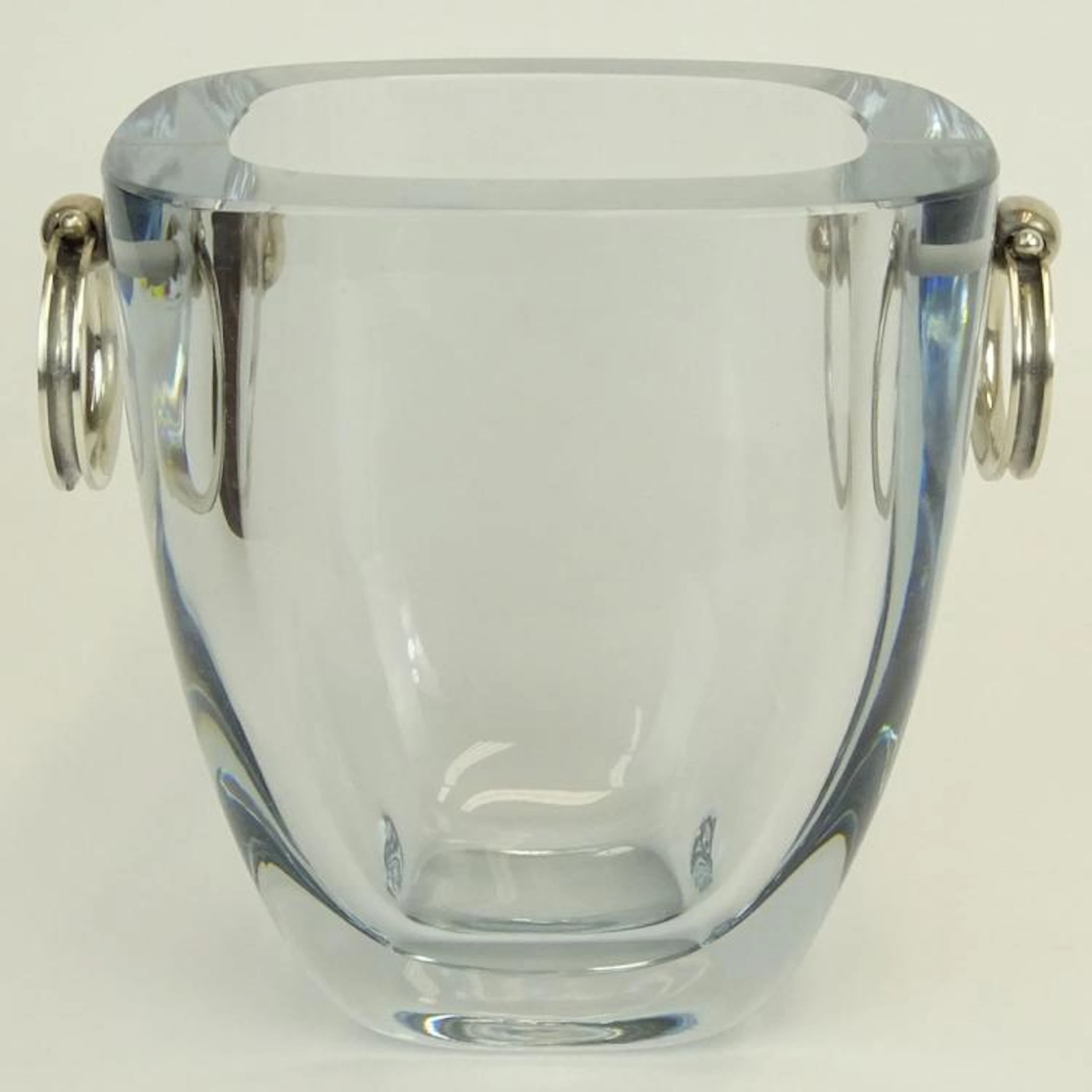 Mid Century Stromberg Shyttan Heavy Ice Blue Crystal Ice Bucket with Silver Ring Handles. Signed. Good condition. Measures 6-1/4" H.