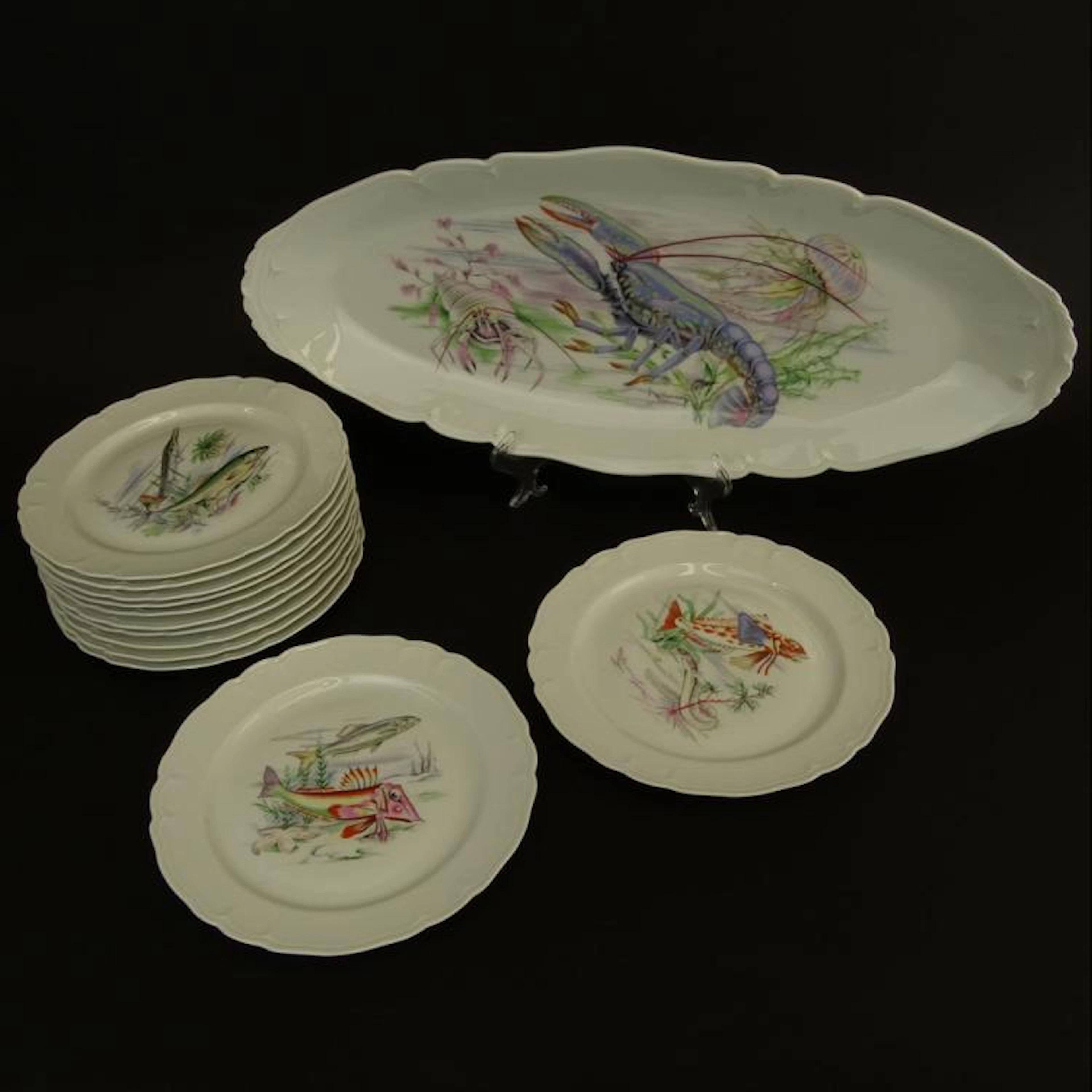 Modern Limoges Thirteen (13) Piece Fish Service. Transferred motif. Signed with Limoges backstamp. Good condition. Includes 12 Plates 9-3/4" and a long platter 24" L. Very good condition. Shipping $12