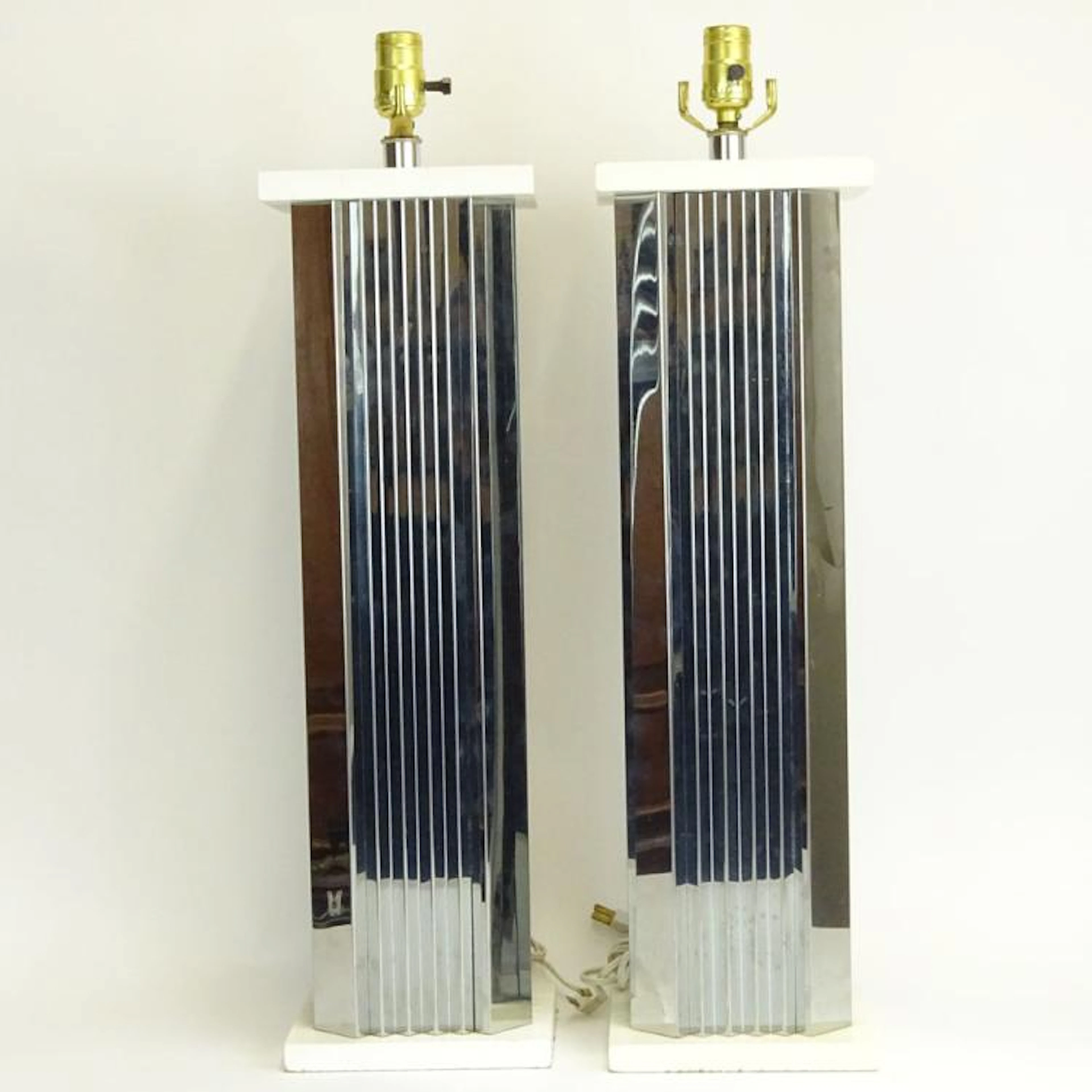 Pair of Mid Century Modern Chrome Finish Table Lamps. Unsigned. Rubbing otherwise good condition. Measure (to base of socket) 23-1/2" H, 7" W.