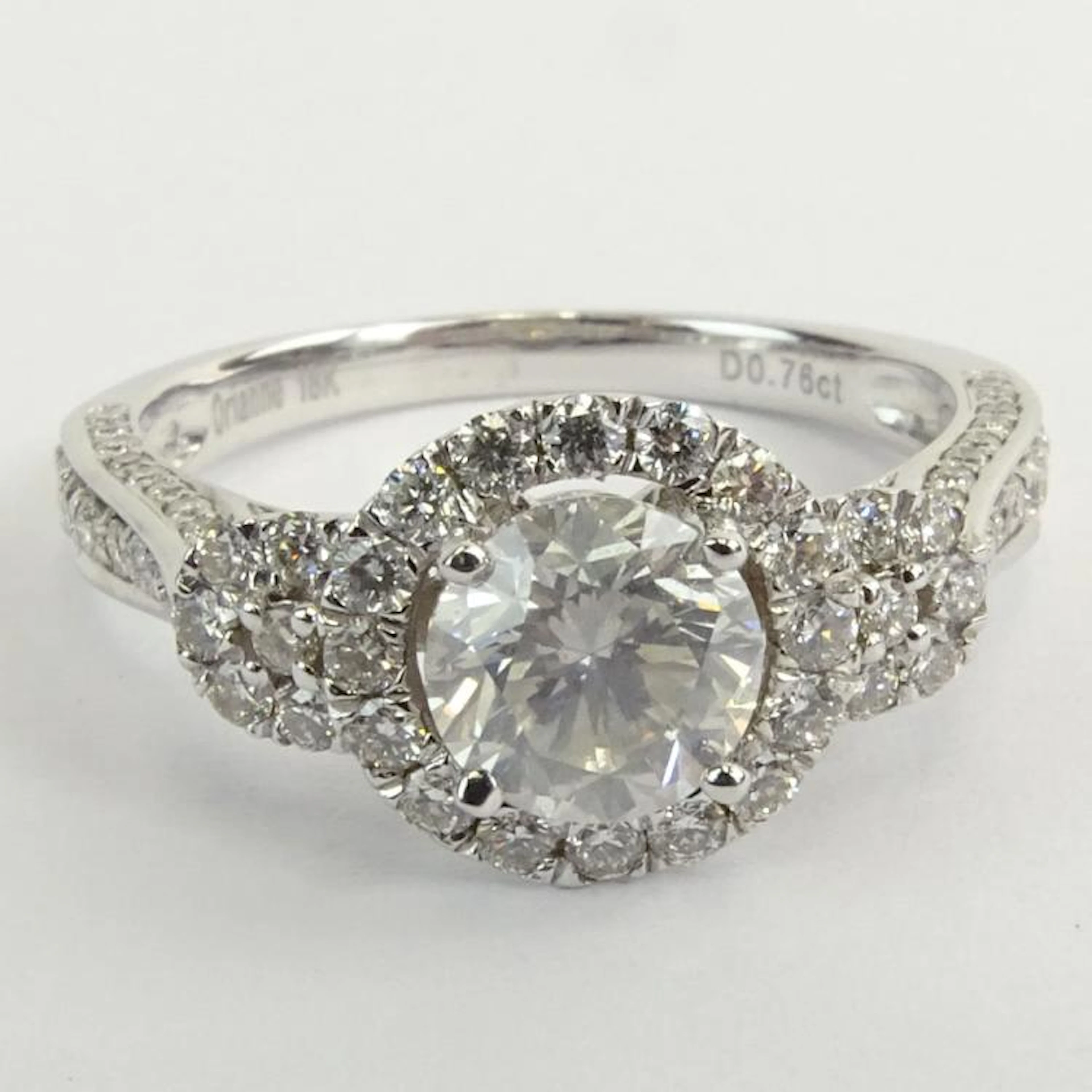AIG Certified Diamond and 18 Karat White Gold Engagement Ring set in the center with a 1.03 Carat Round Brilliant Cut Diamond and accented throughout with .75 Carat Round Brilliant Cut Diamonds. Cente