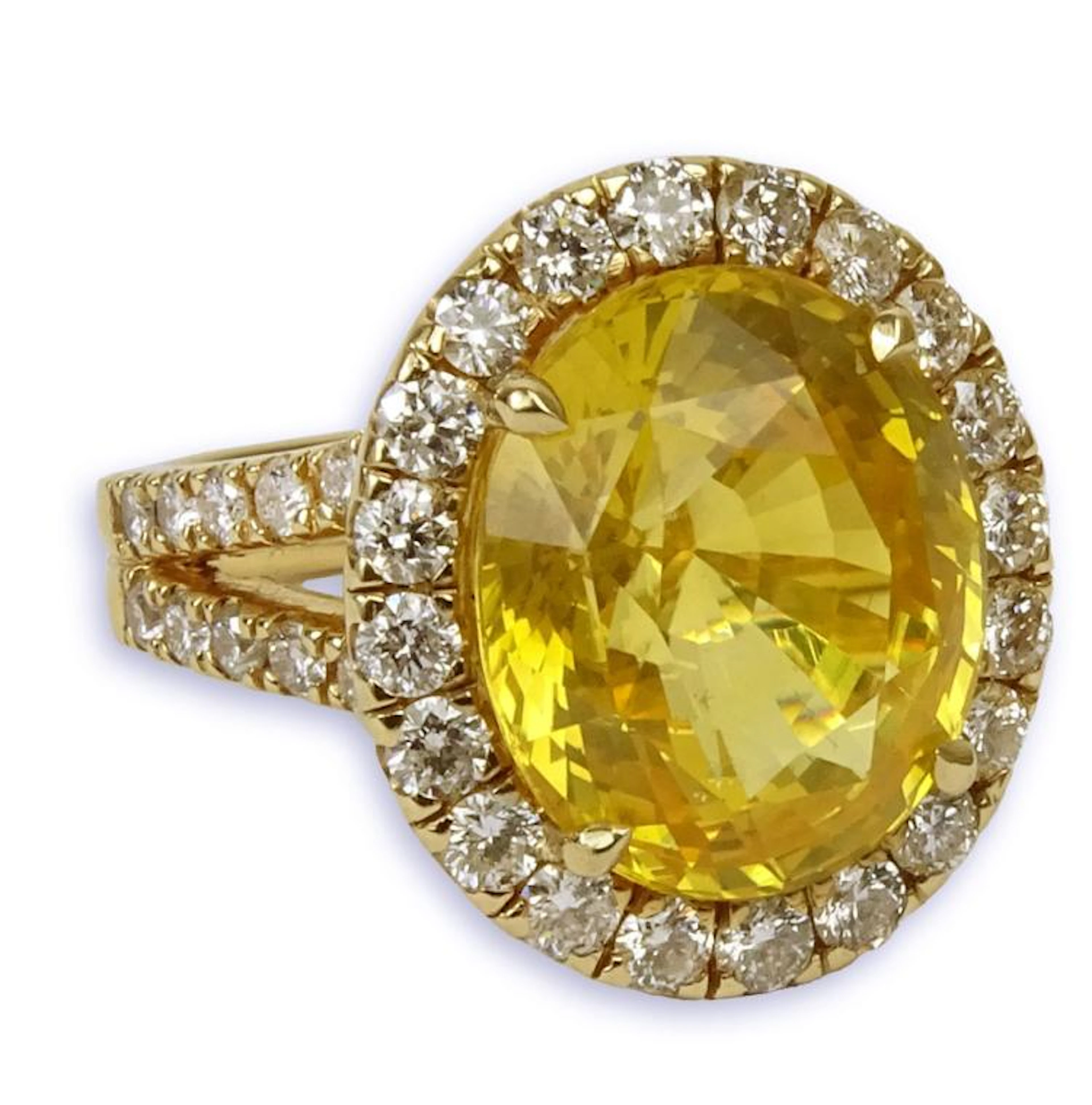 GIA Certified 12.65 Carat Oval Cut Yellow Sapphire and 18 Karat Yellow Gold Ring accented throughout with Round Brilliant Cut Diamonds. Sapphire with vivid saturation of color. Diamonds F-G color, VS-