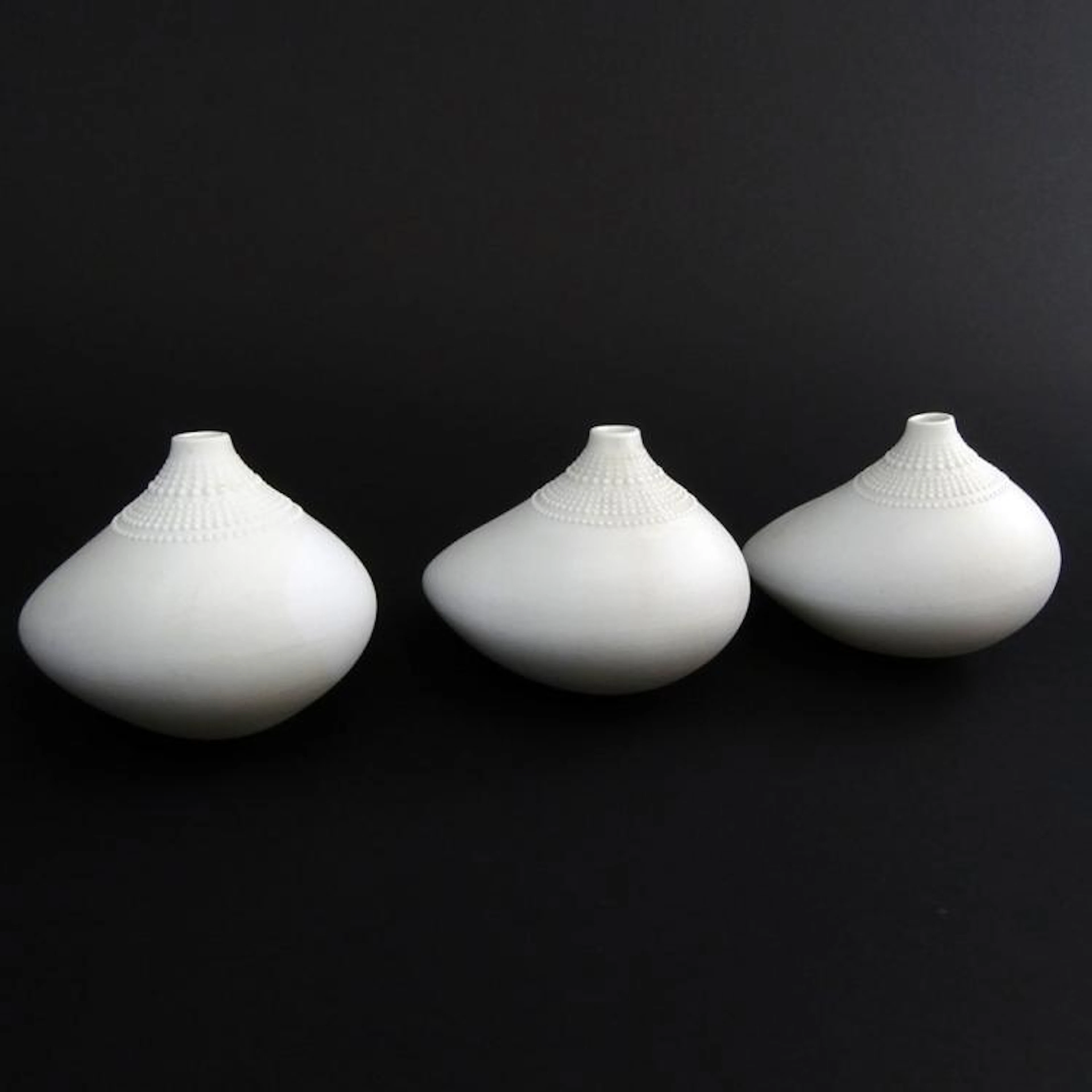 A group of three (3) Mid Century Rosenthal Studio Linie White Ceramic "Pollo" vases designed by Tapio Wirkkala, Finland for Rosenthal Studio Line. C 1973. Signed. Good condition. Measures 3-1/2" H x 4