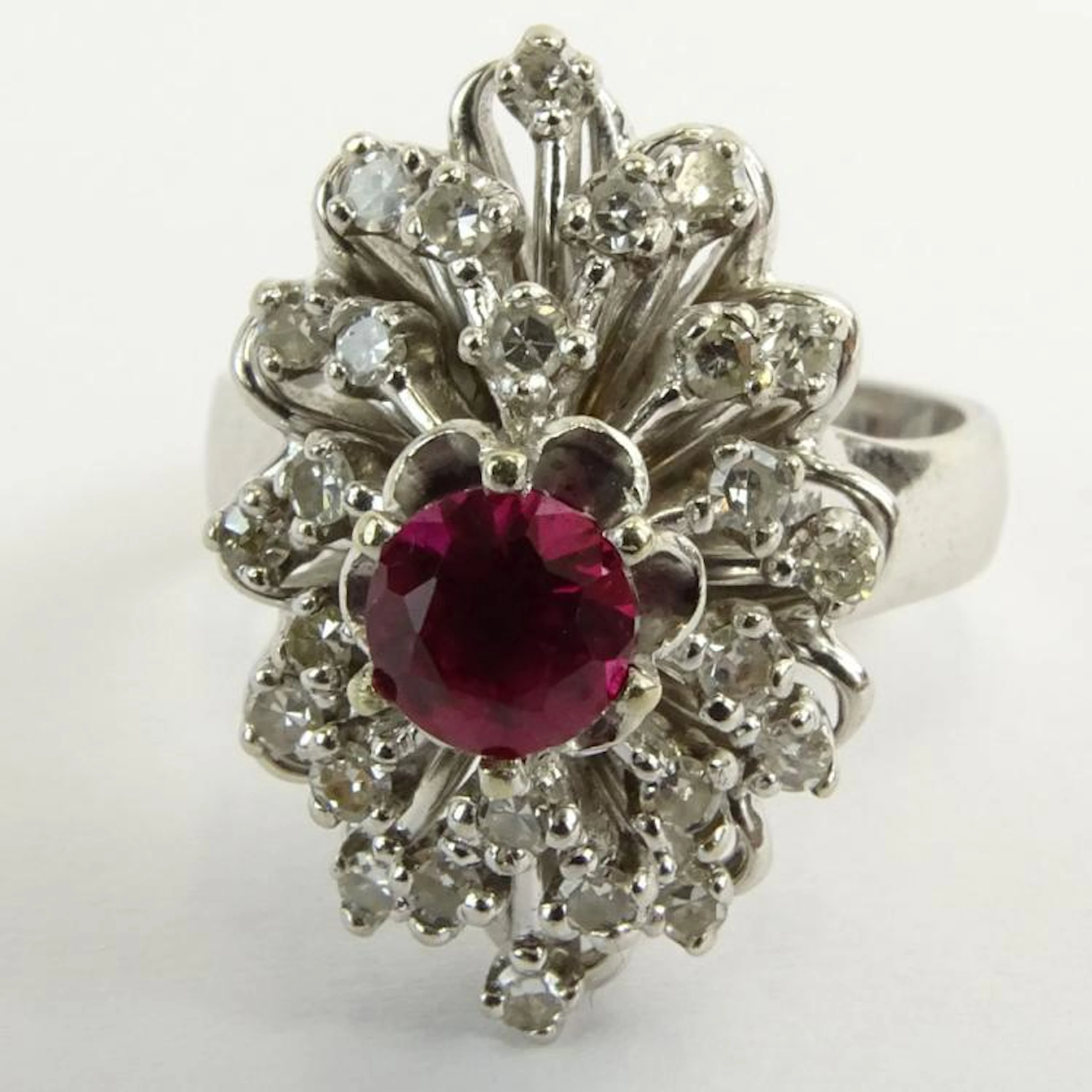 Vintage Round Cut Ruby, Round Cut Diamond and 18 Karat White Gold Ring. Signed 18K. Good vintage condition. Ring size 7-1/2. Approx. weight: 6.80 pennyweights