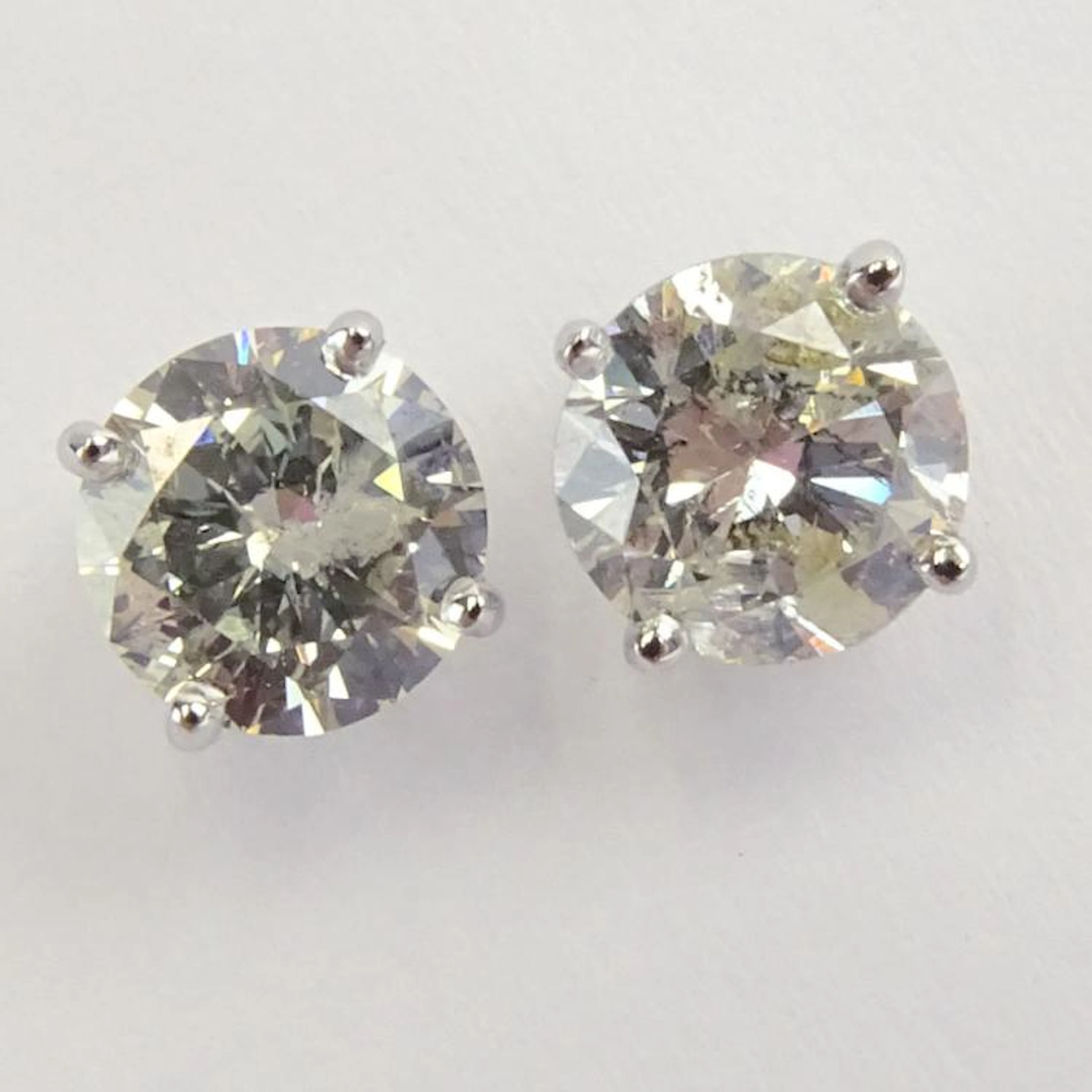 AIG Certified 1.57 Carat, total weight, Round Brilliant Cut Diamond and 14 Karat White Gold Earstuds. Diamonds K-L color, I1 clarity. Very good condition. AIG Report 000715240016 dated 8/28/15 to acco
