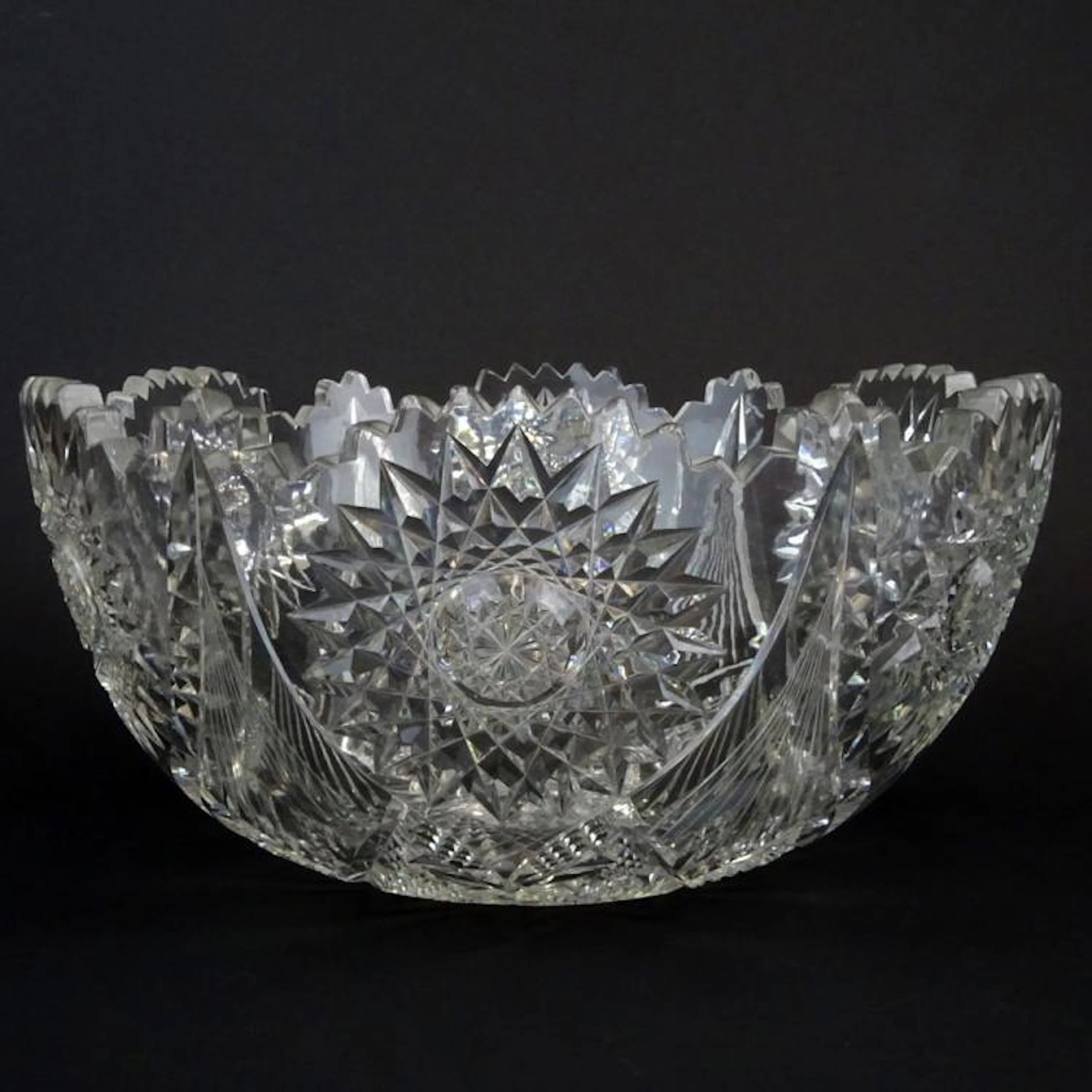 Antique Cut Glass Punch Bowl. Unsigned. Minor flea bite chips. Measures 6-1/4" H x 13" dia. Heavy.