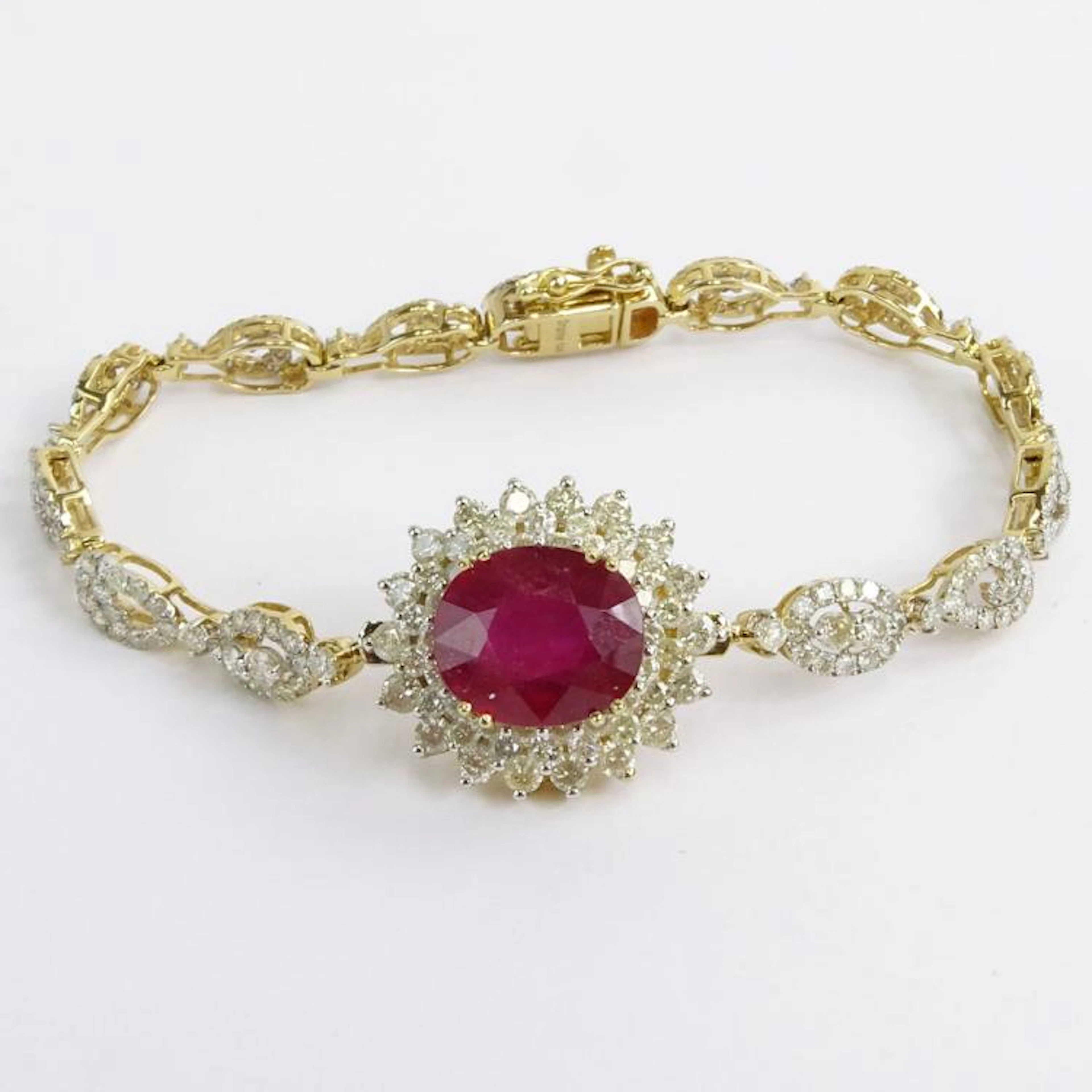 AIG Certified 7.45 Carat Oval Cut Ruby, 5.18 Carat Round Brilliant Cut Diamond and 14 Karat Yellow Gold Bracelet. Ruby with vivid saturation of color. Diamonds J-L color, SI2-I2 clarity. Signed 14K. V