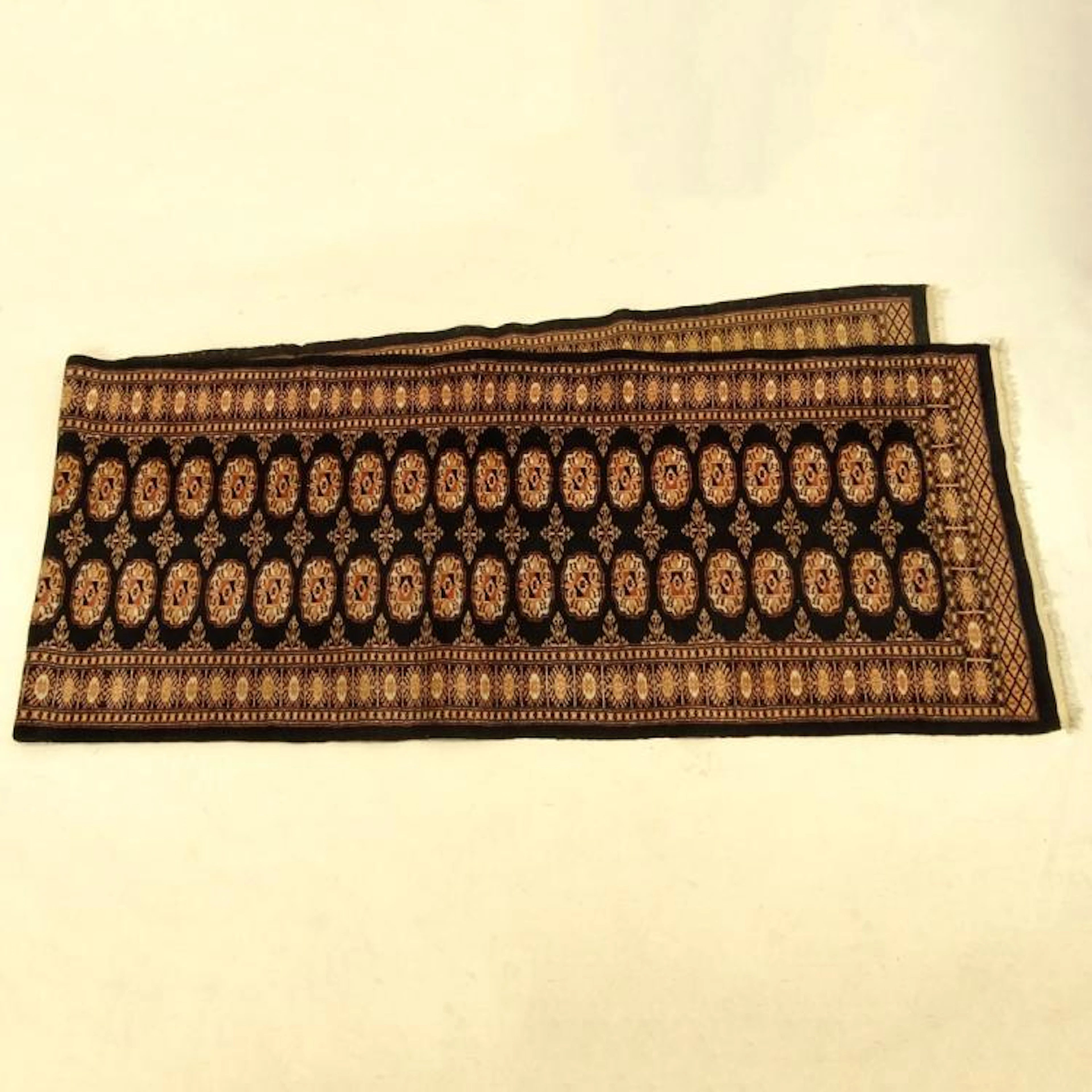 Modern Pakistani Bokara Runner. Labeled. Good condition. Measures 149" x 32".