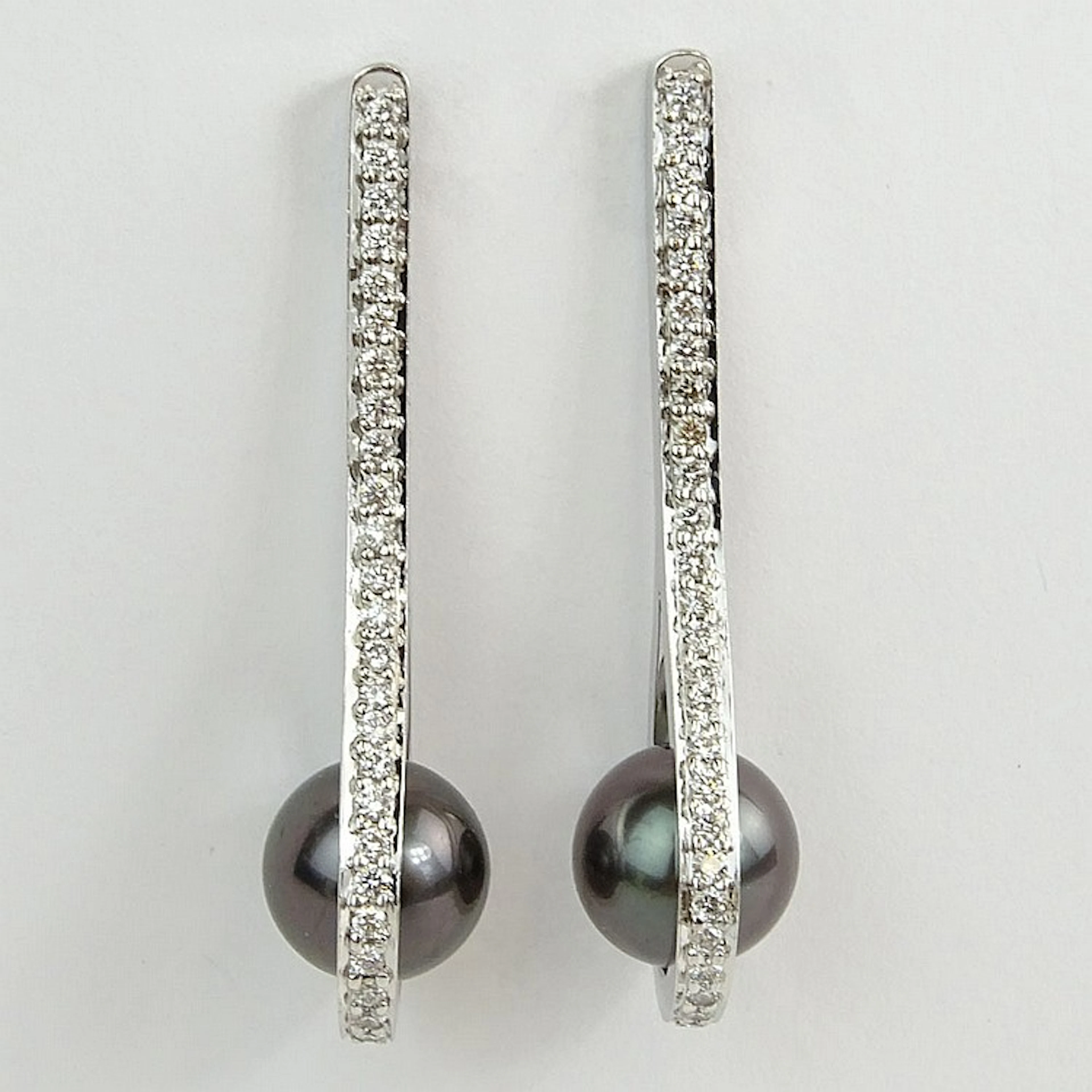 Pair of Lady's Silver Black Tahitian Pearl and 14 Karat White Gold Earrings Accented throughout with Approx. .50 Carat Round Brilliant Cut Diamonds. Pearls measure 8.75mm. Diamonds F-G color, VS1-VS2 