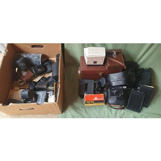 A collection of vintage cameras, accessories, cases & lens covers.