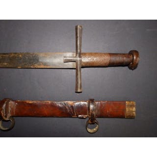 A late 19thC Kaskara sword with leather hilt & scabbard, the blade 25".