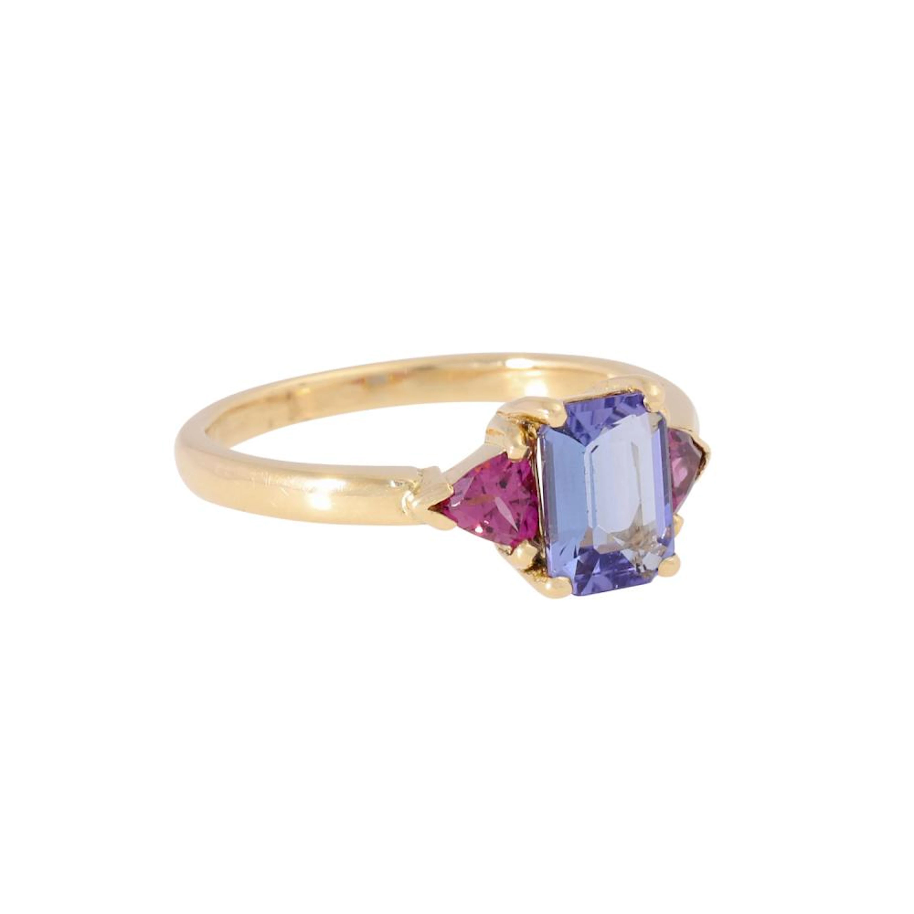 Ring with tanzanite flanked by rhodolite triangle,
