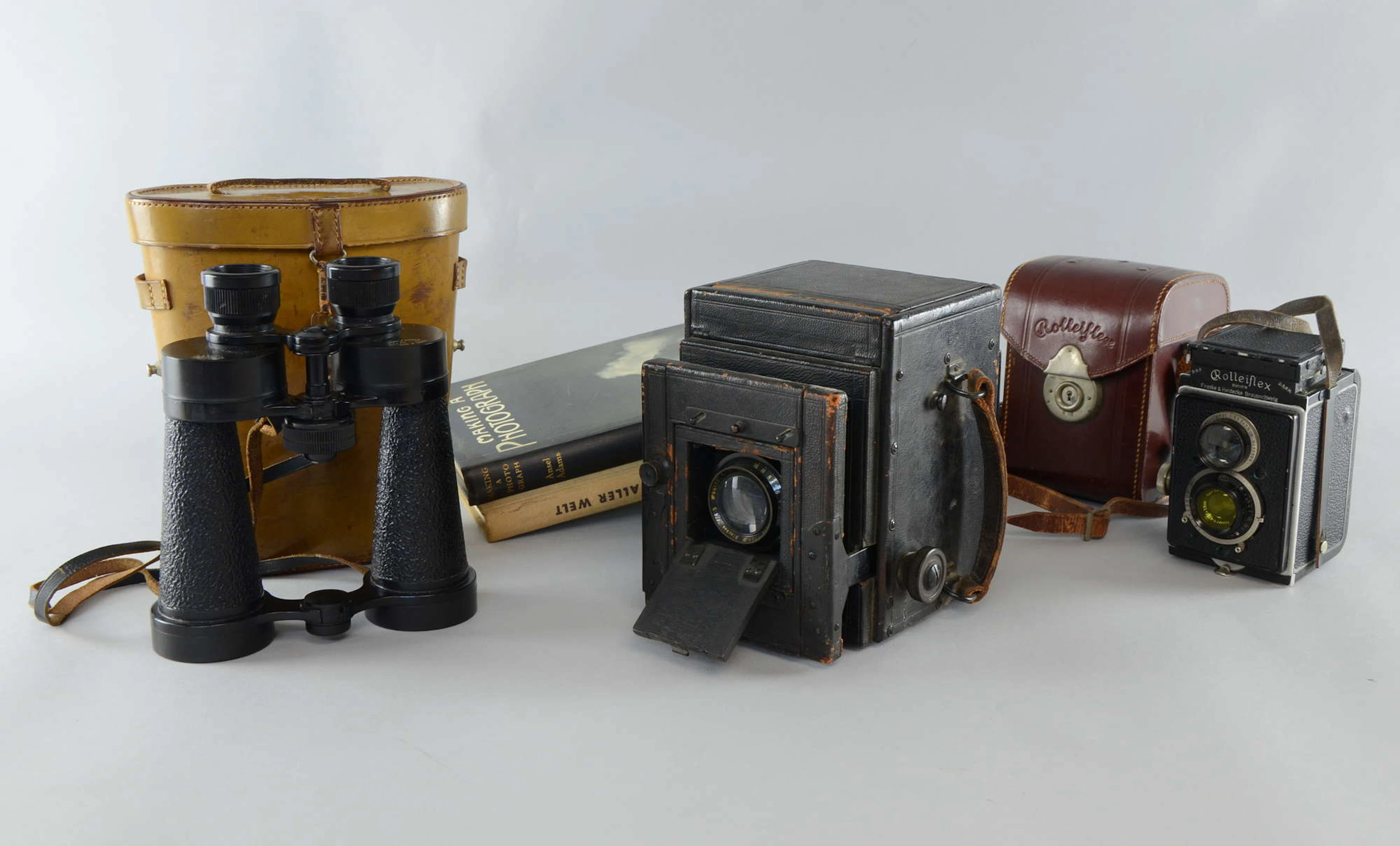A bellows plate film camera with T-P Cooke Anastigmat lens and bearing label
