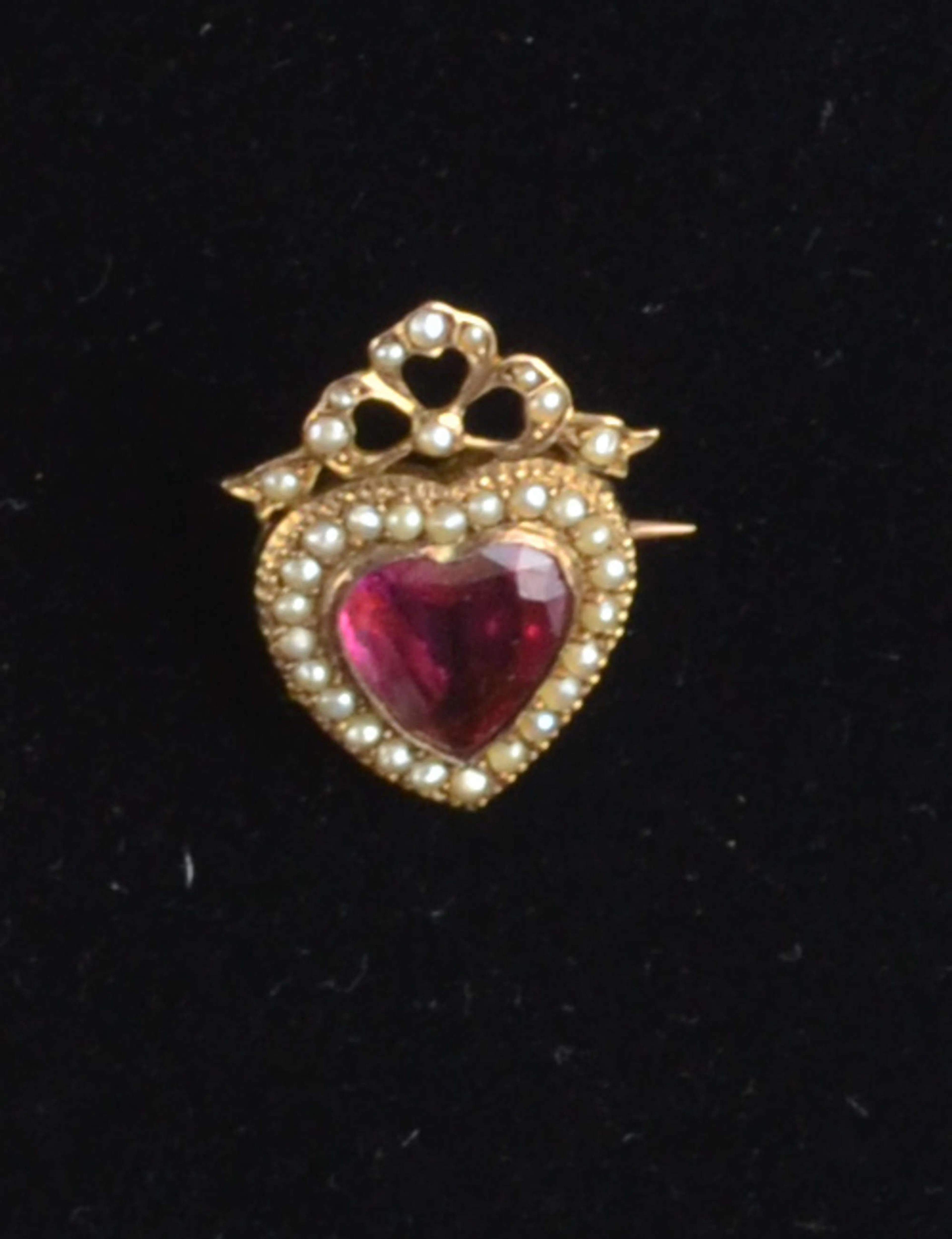 Victorian gold heart brooch with central red stone and seed pearls and a bar brooch with lyre PROVENANCE: This lot is part of a unique Kipling family archive which has come through Helen Macdonald