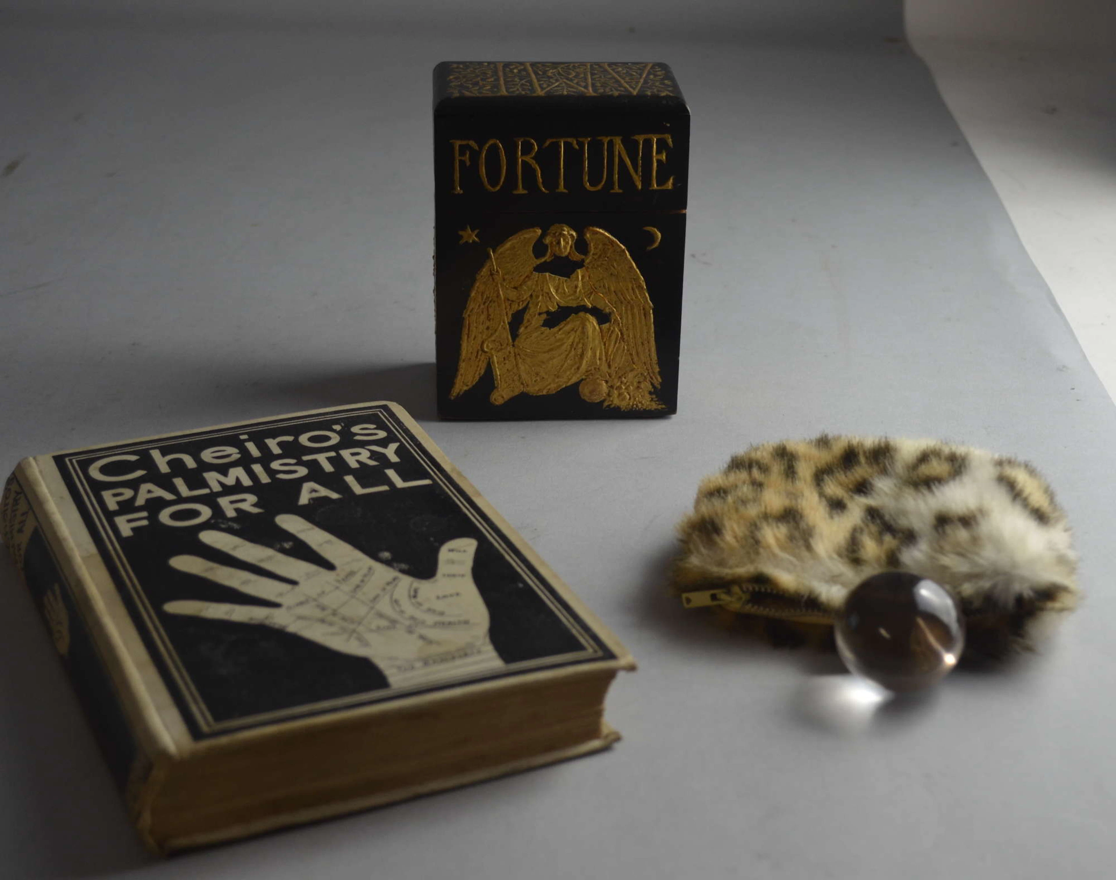 Trix Kipling's black painted and gilt decorated box containing her fortune telling paraphernalia and her crystal ball