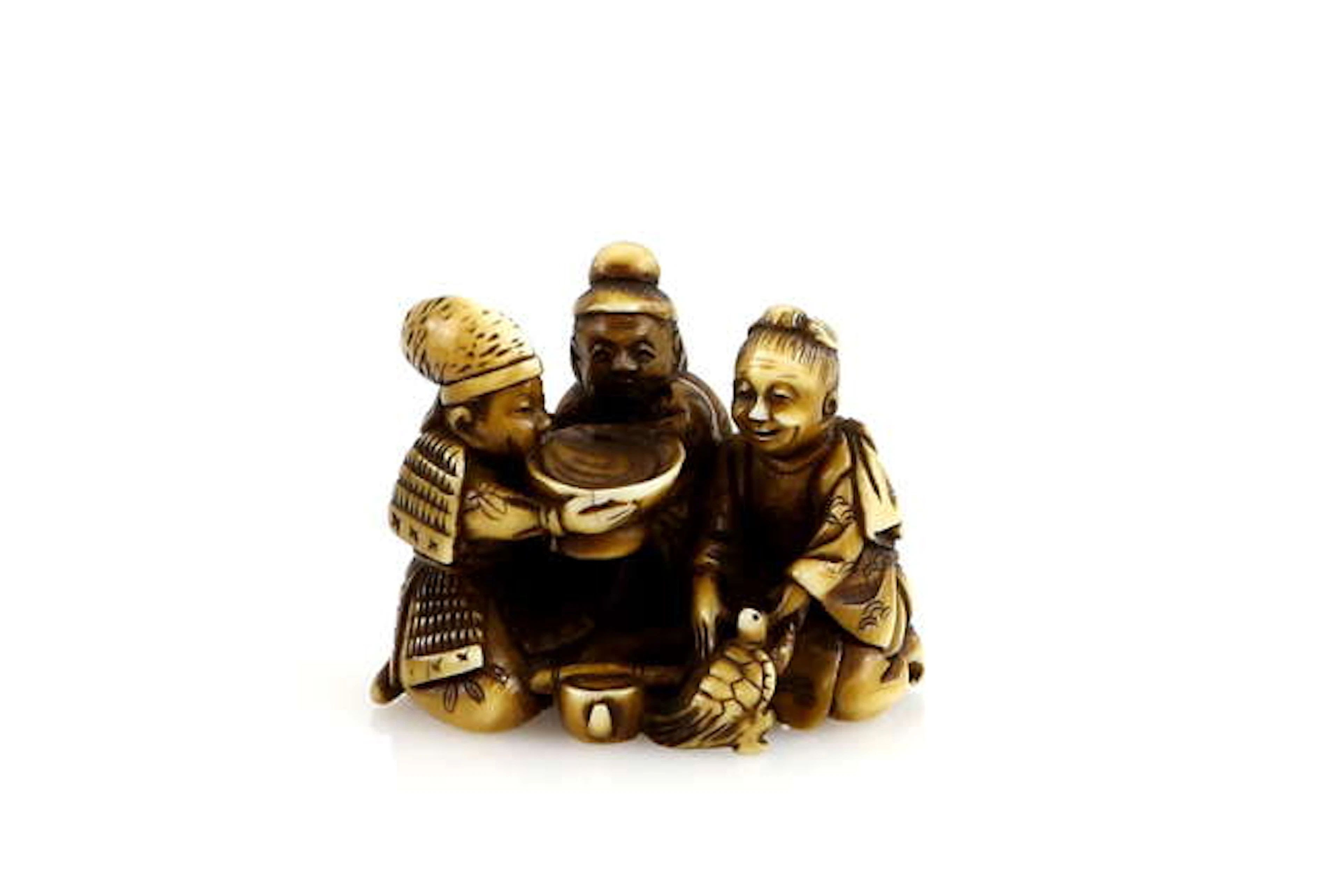 A stained ivory netsuke carved as Three Sake tasters with...