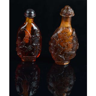 Two amber Chinese snuff bottles; one decorated with figures and one