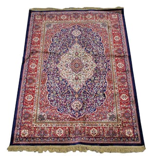 A Kashmir Blue ground rug with traditional floral medallion.