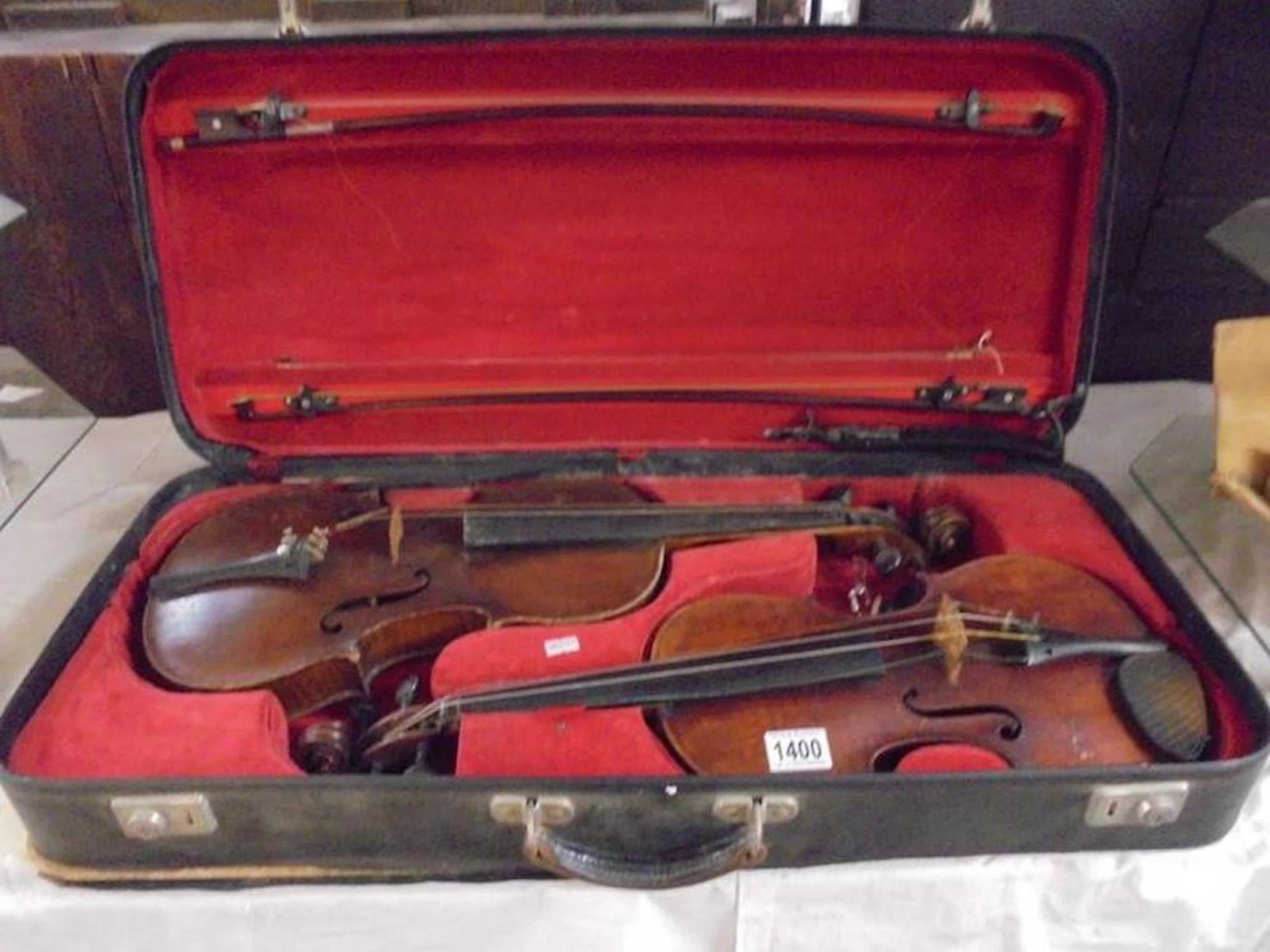 A rare cased pair of antique violins with bows