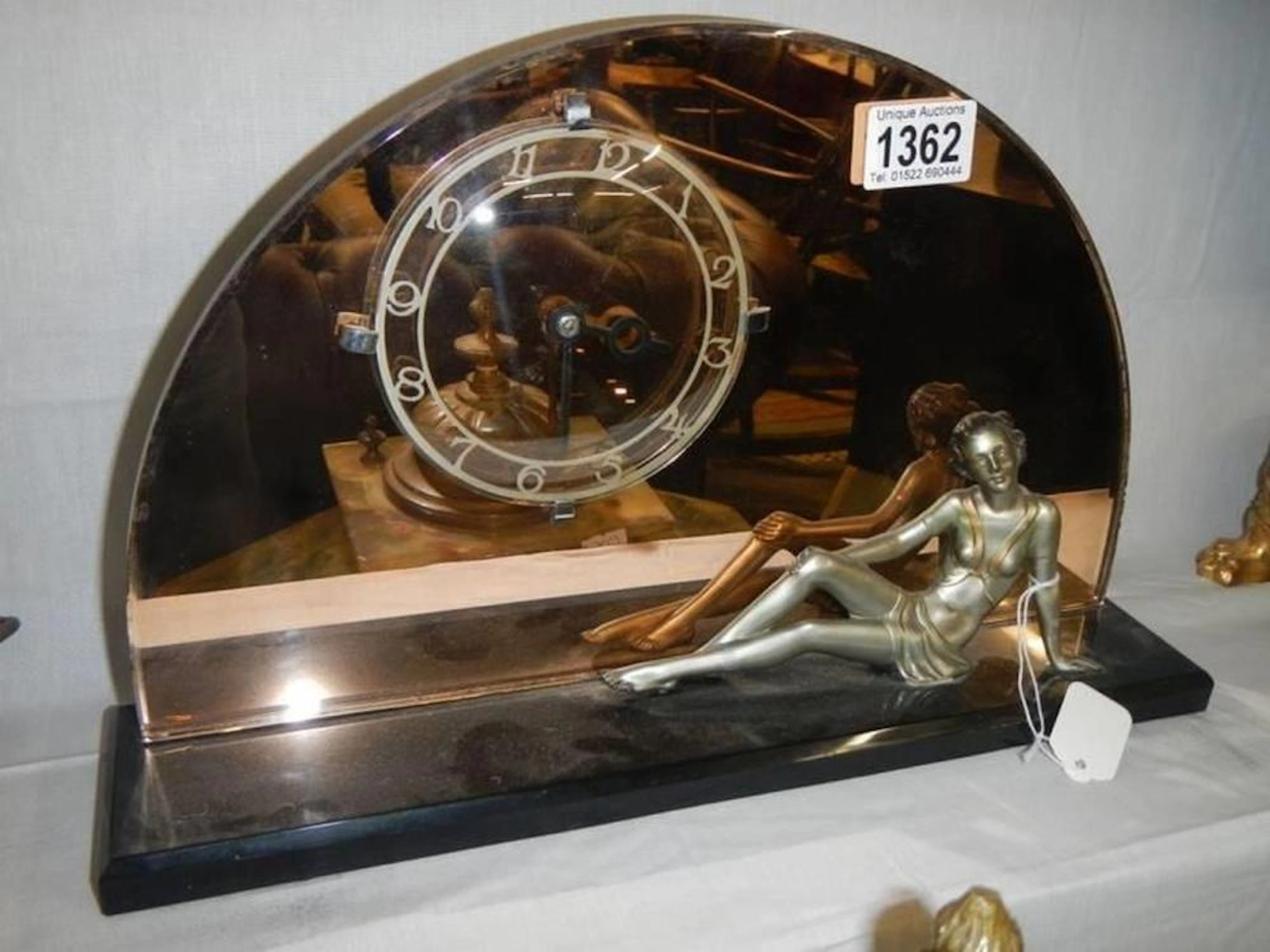 An art deco clock surmounted figurine. COLLECT ONLY.