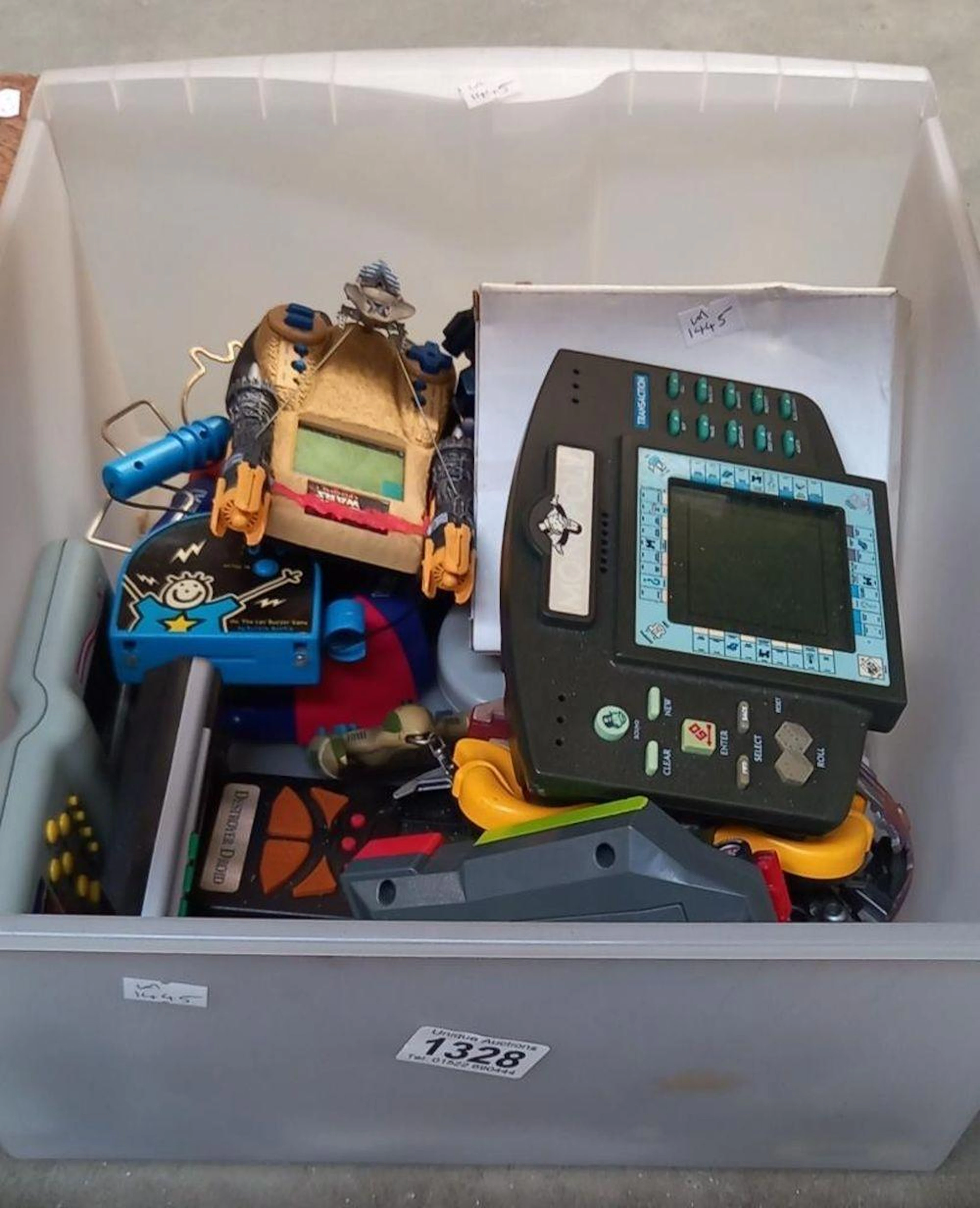 A box of vintage hand held electronic games
