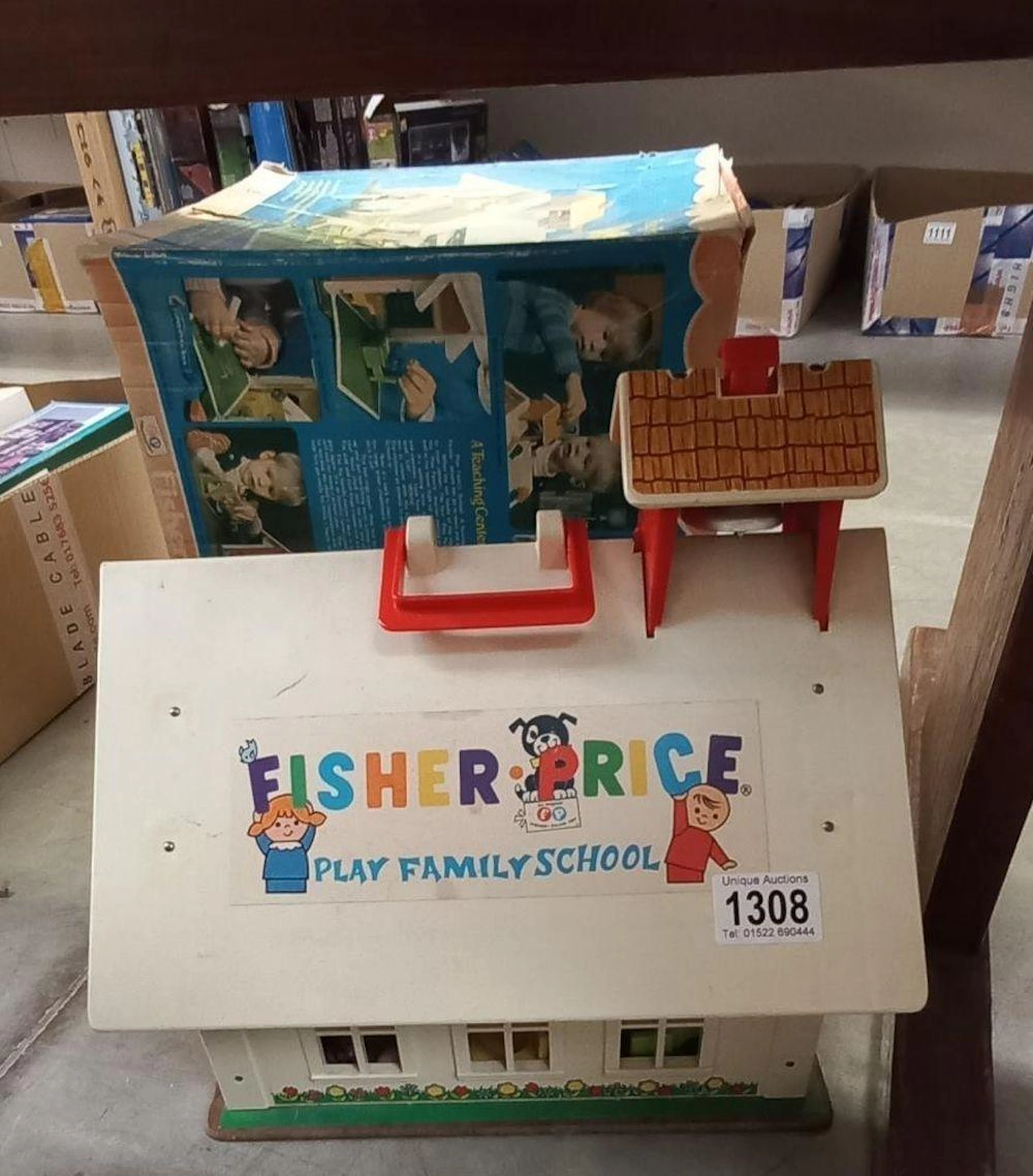 A boxed Fisher Price play family school