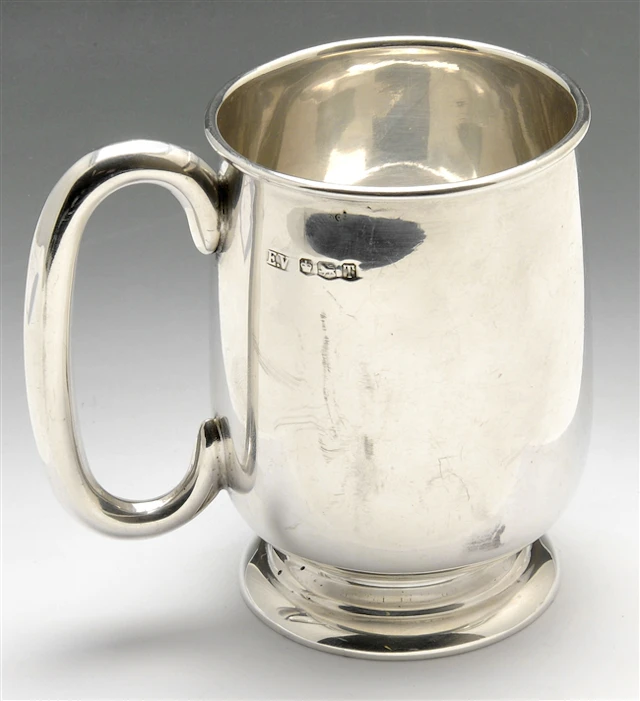 Silver mug and coffee spoons.