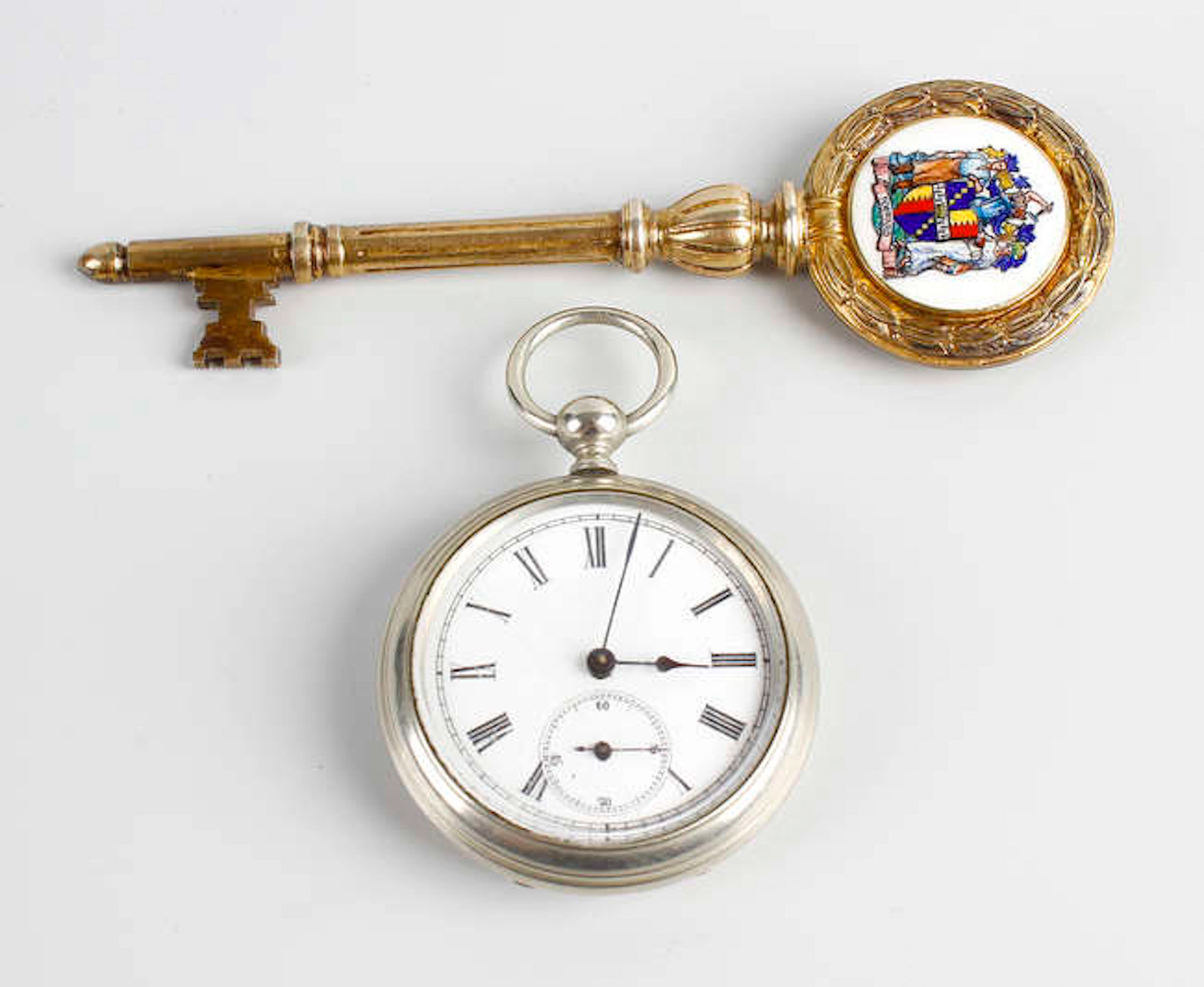 A Birmingham Transport silver-gilt and enamel presentation key, plus an Argentinean pocket watch