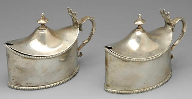 A pair of Edwardian silver mustard pots, a further mustard pot & a pepper pot. (4).