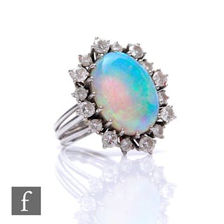 An 18ct white gold opal and diamond cluster ring, central ov...