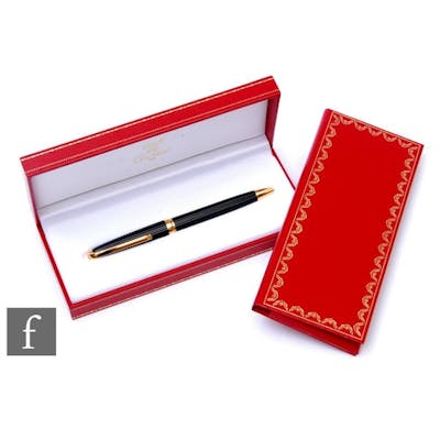 A Must De Cartier black lacquer rollerball pen complete with...