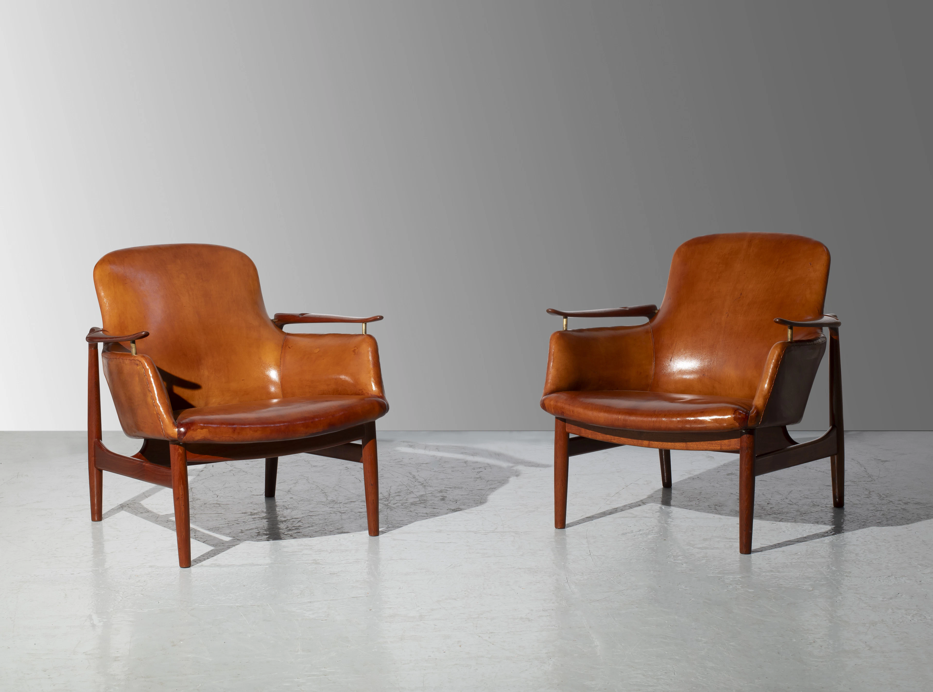 A pair of mahogany and leather mod