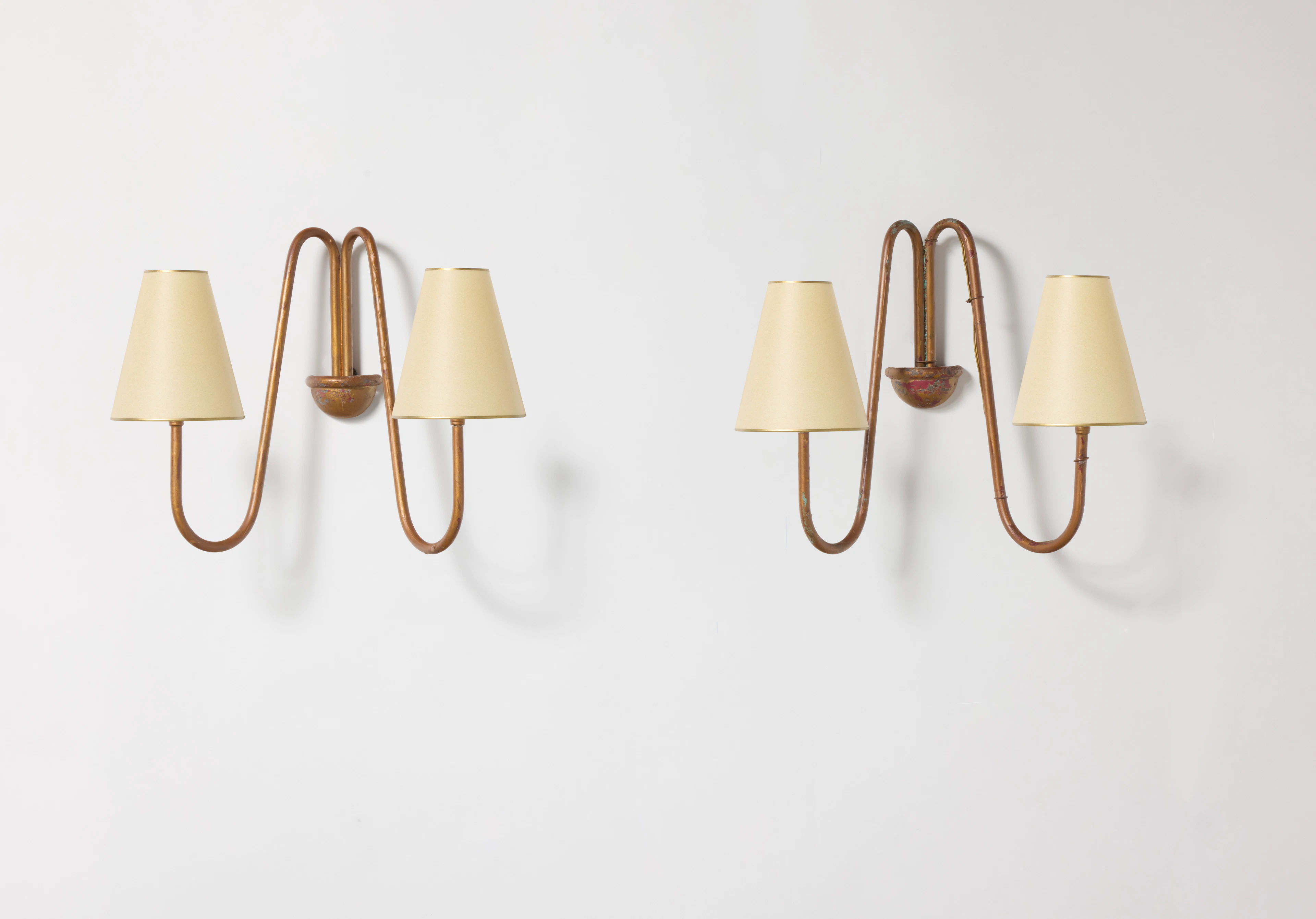 A pair of “Bouquet” sconces in gilded tubular metal by...