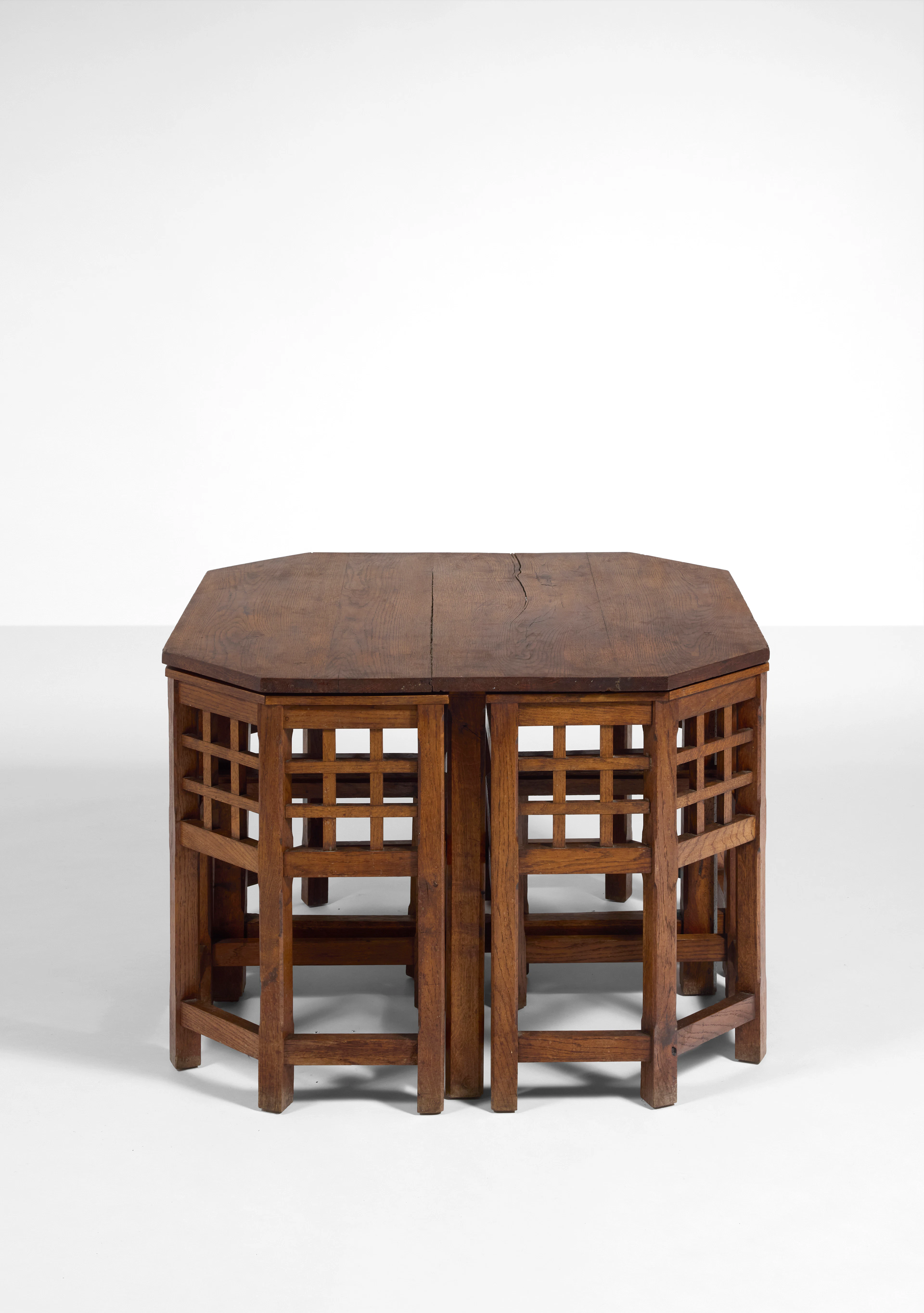 An oak game table and its four armchairs by Francis...
