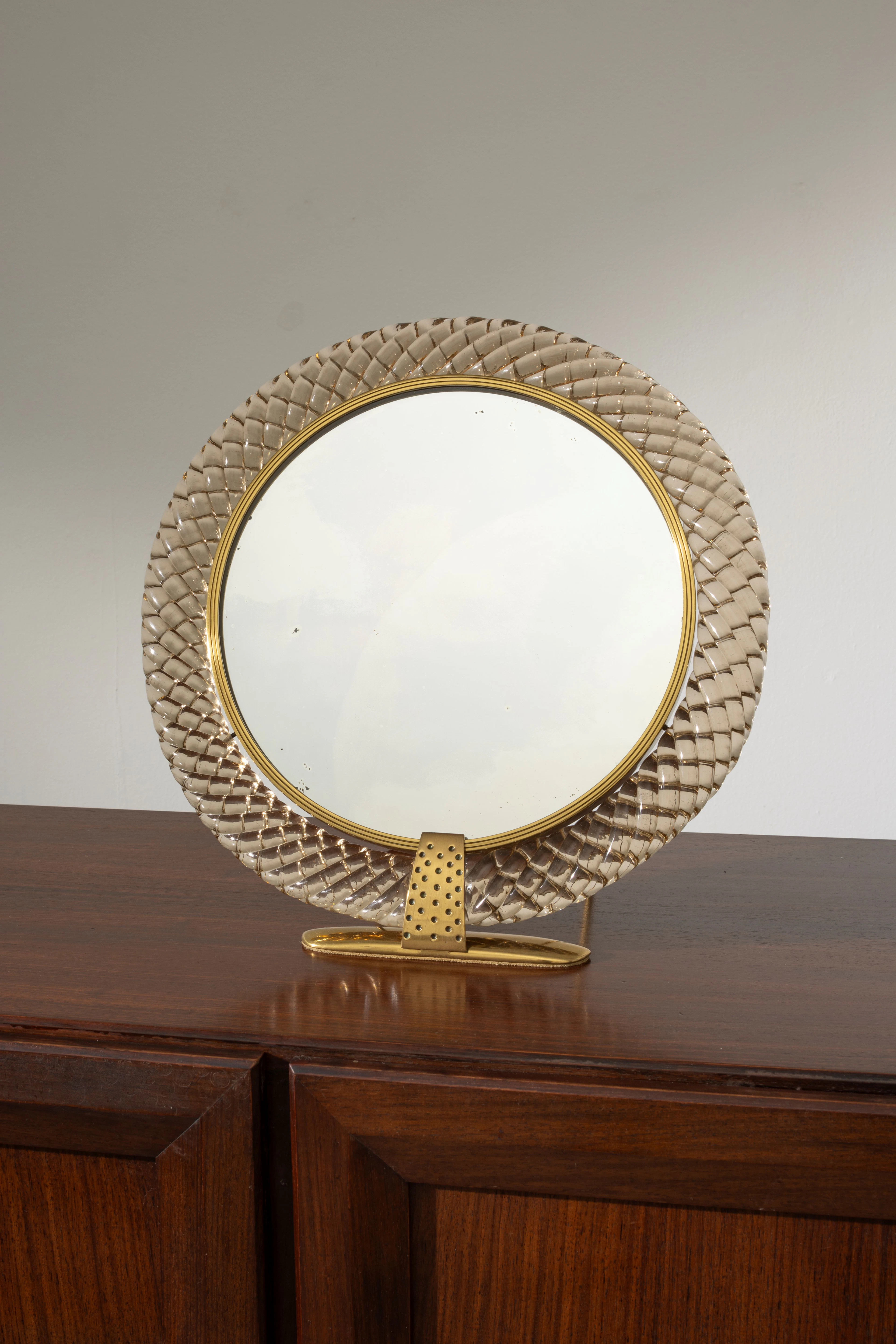 A brass and glass table mirror by Carlo Scarpa for Venini...