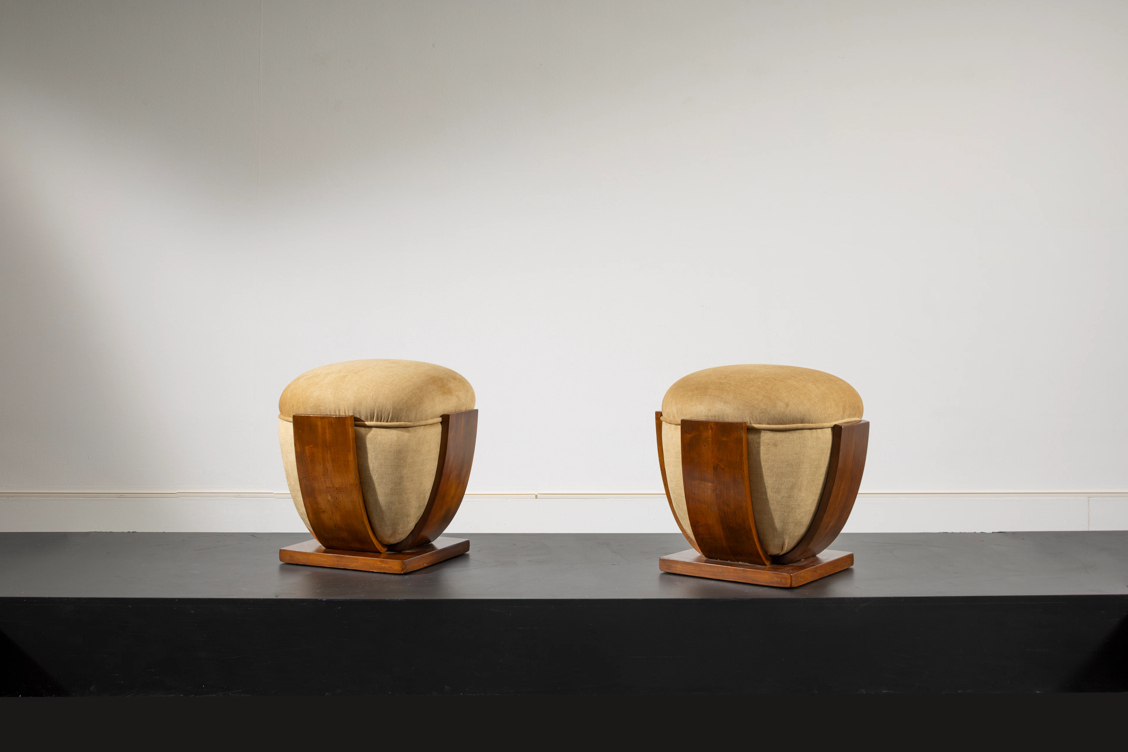 A pair of walnut and velvet stools by Osvaldo Borsani...