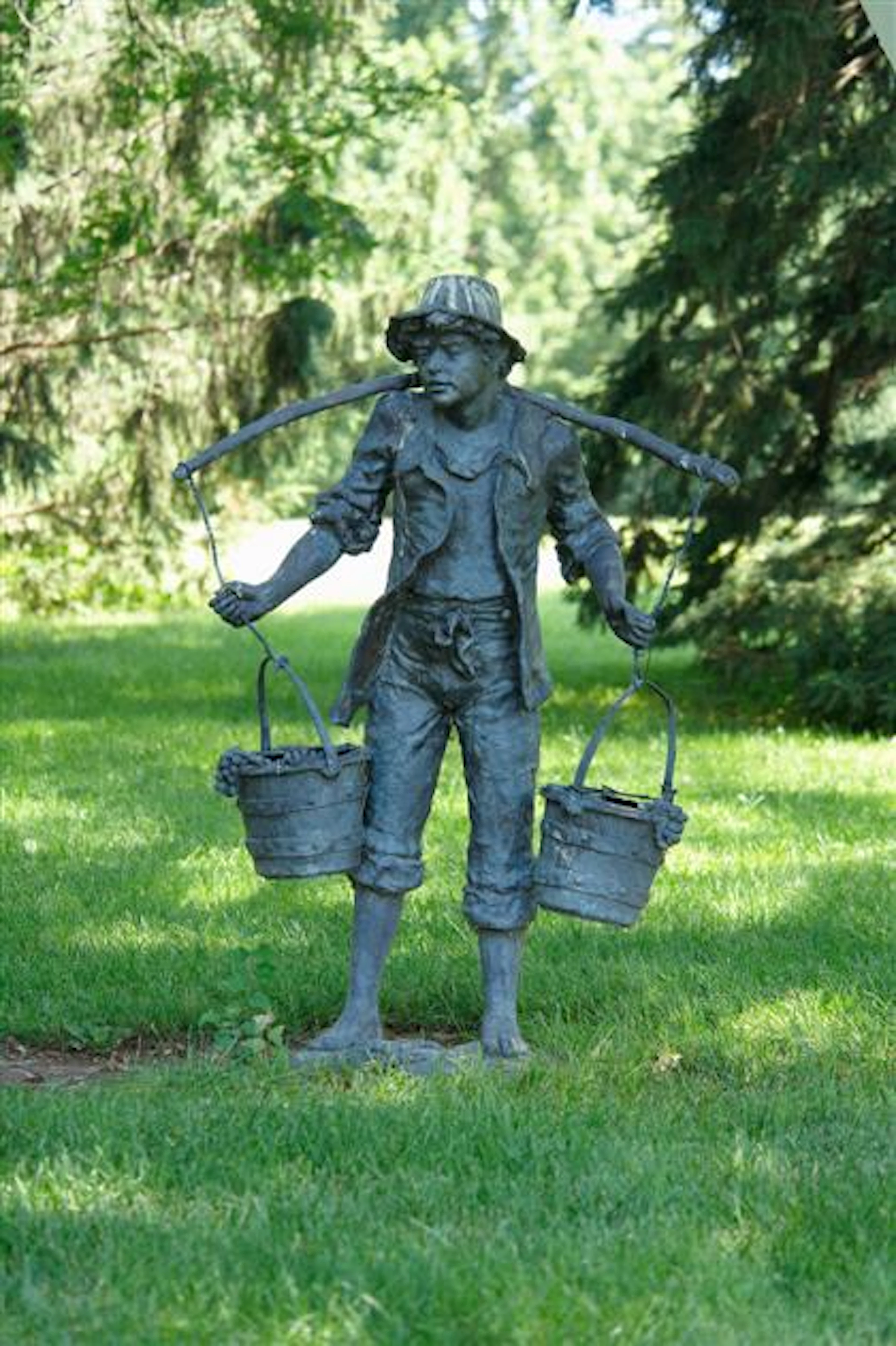 Large patinated figure of a standing boy carrying two pails of grapes, 20th century