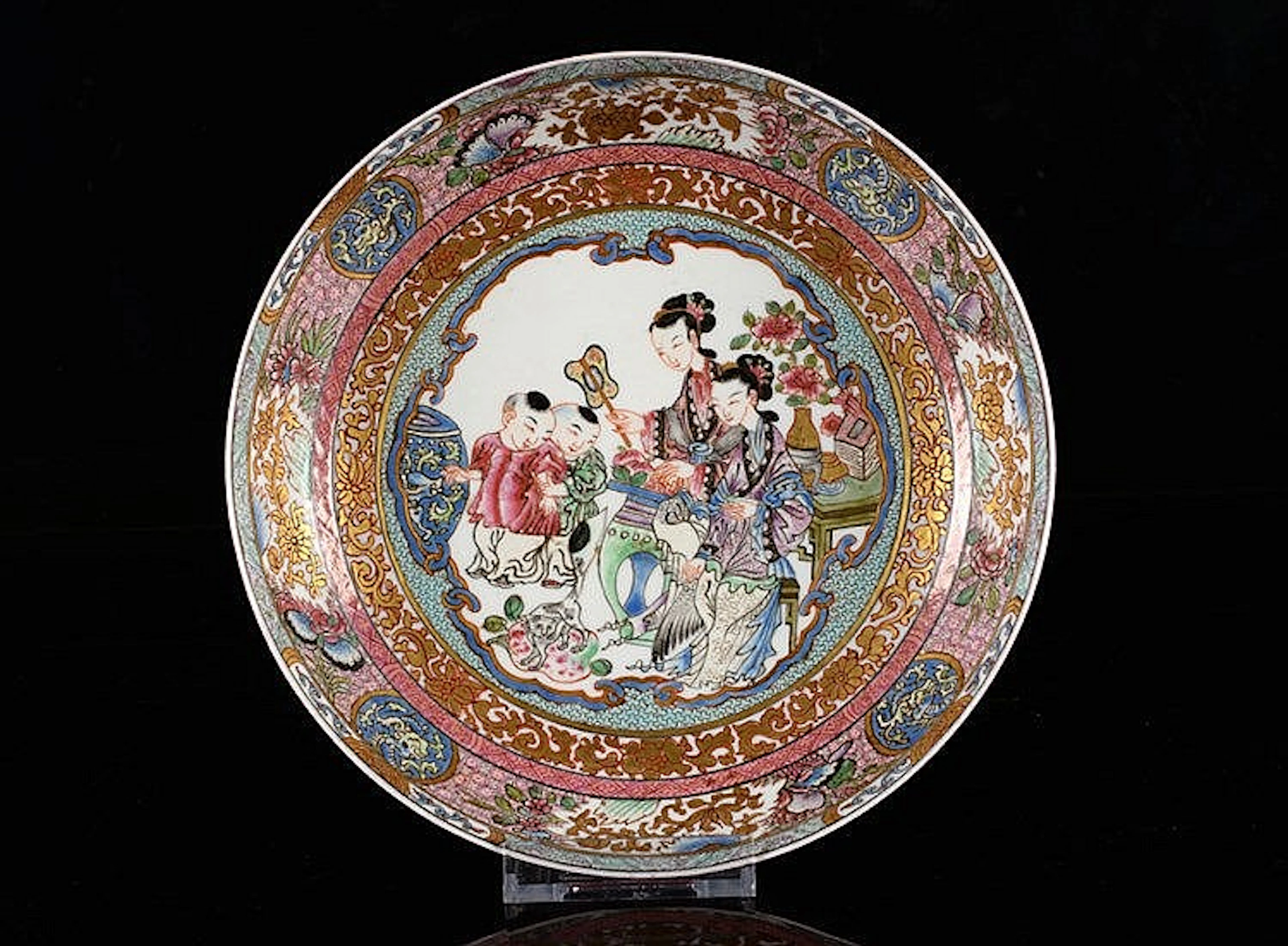 A polychrome porcelain plate, decorated with long