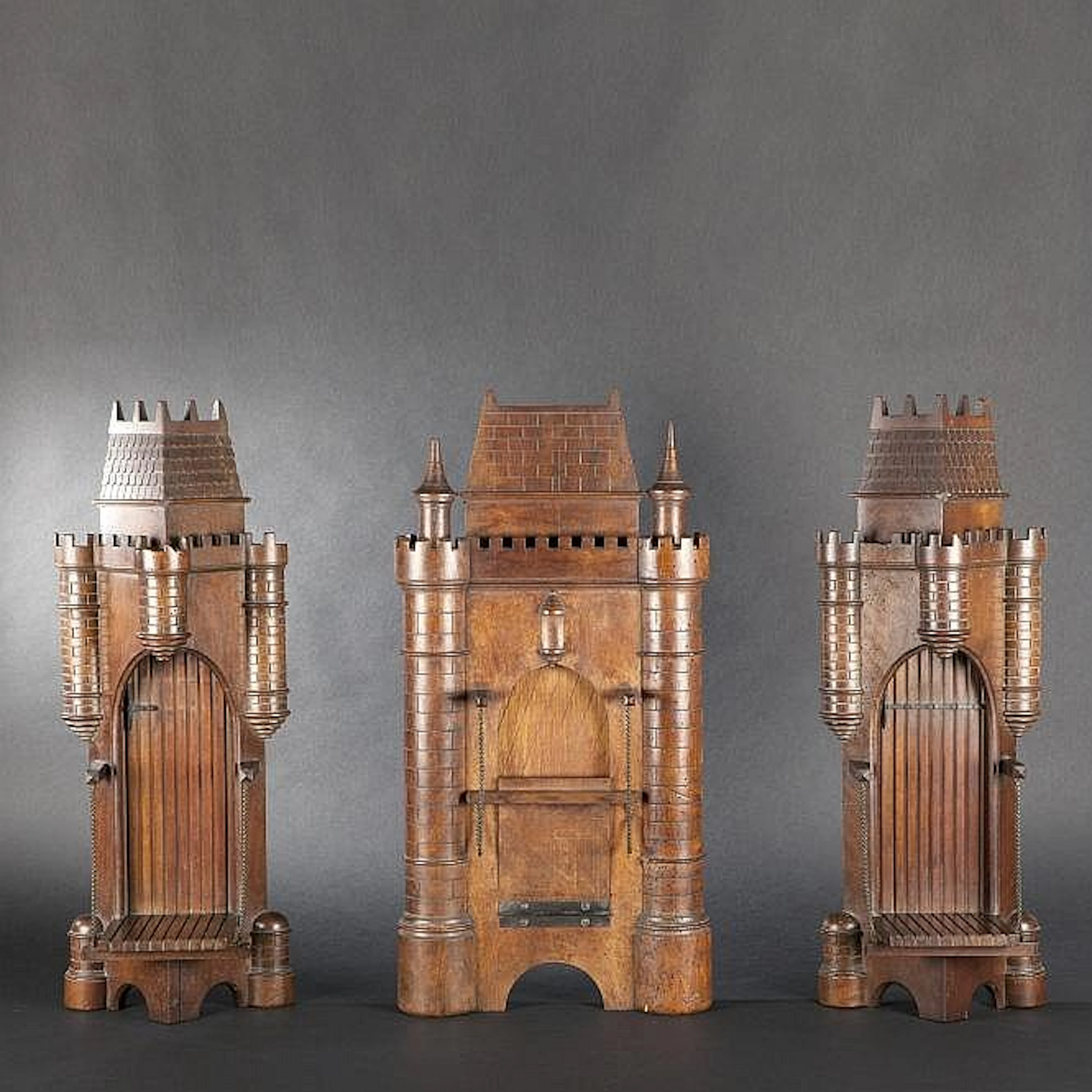 Three wall consoles in the shape of Neo-Gothic donjons