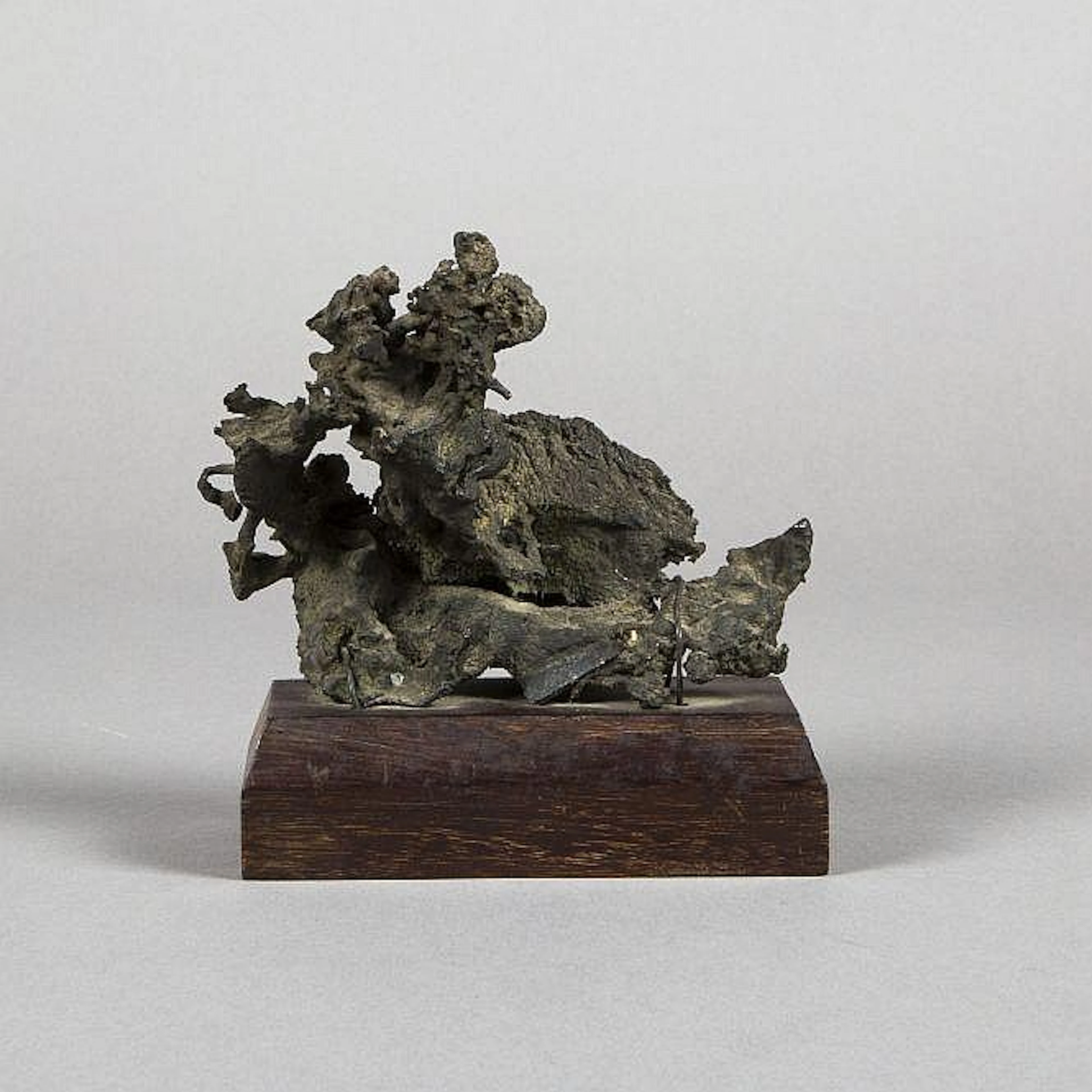 Bronze bell fragment atop wood plinth