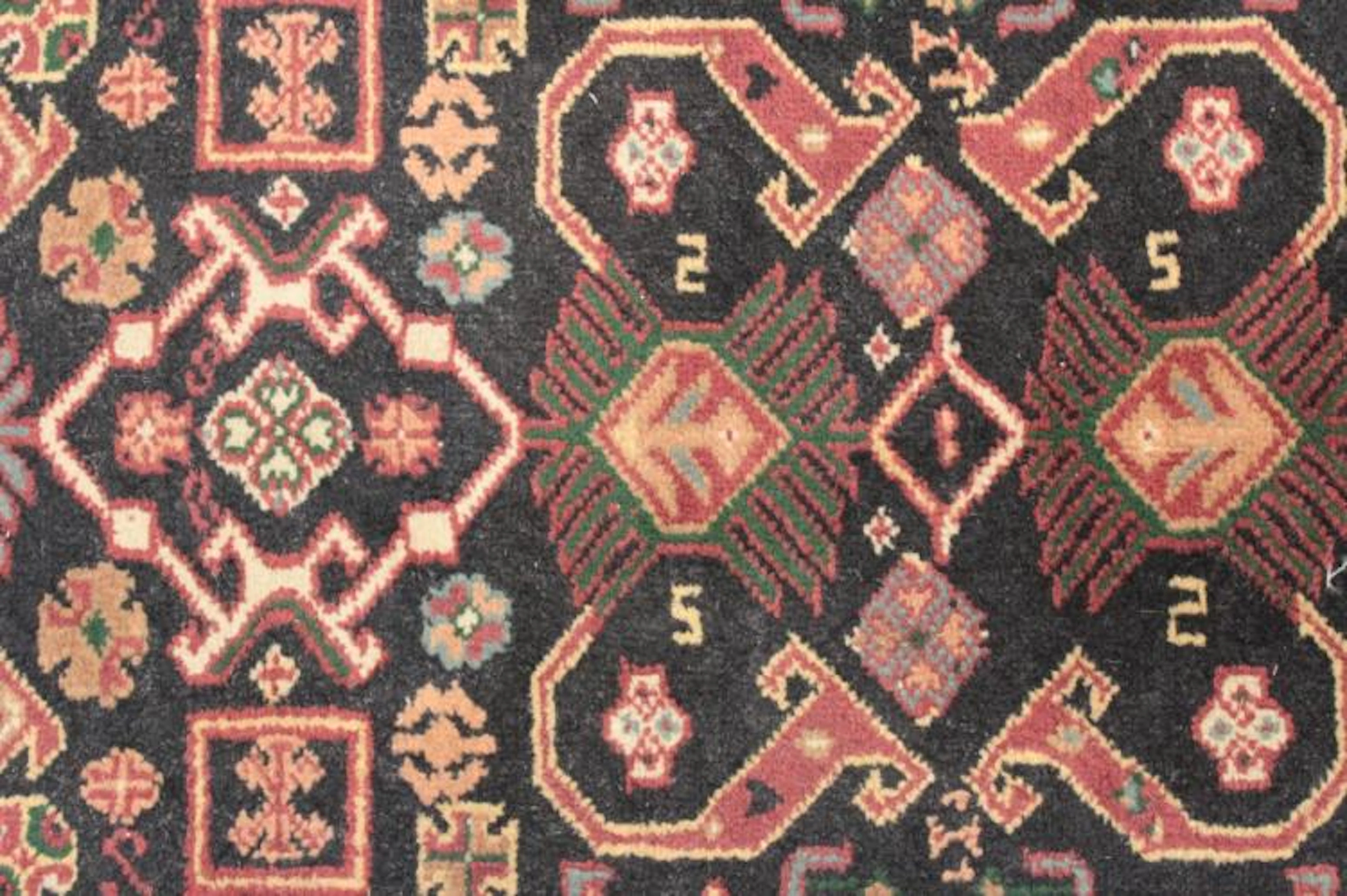 Two Oriental Rugs - Black & Red Grounds