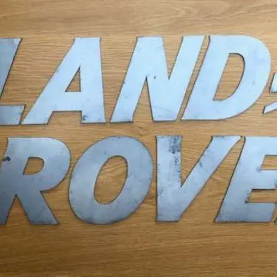 A font-correct 'Land Rover' sign in lazered-steel cut-outs | Barnebys