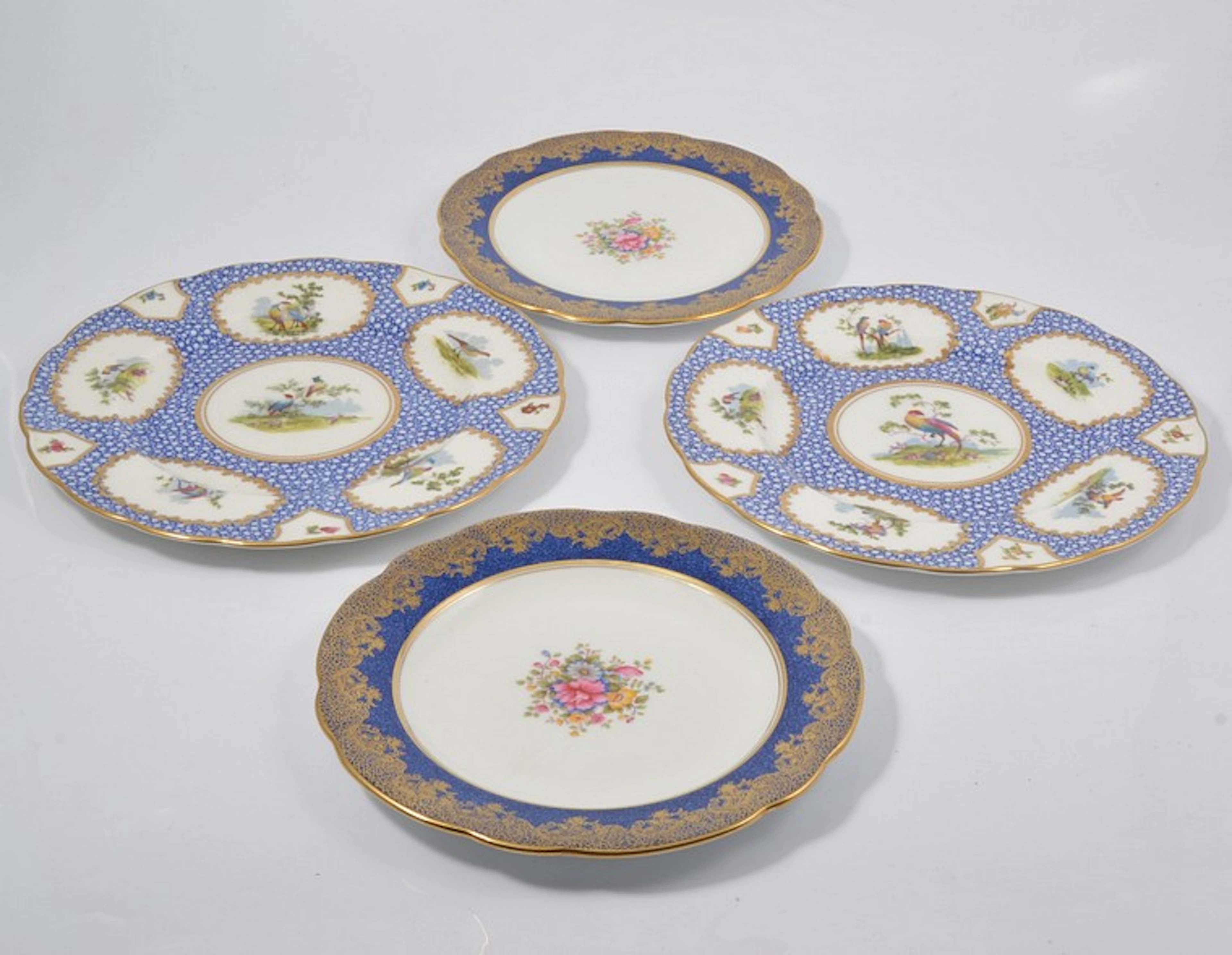 Pair of George Jones plates decorated with exotic birds
