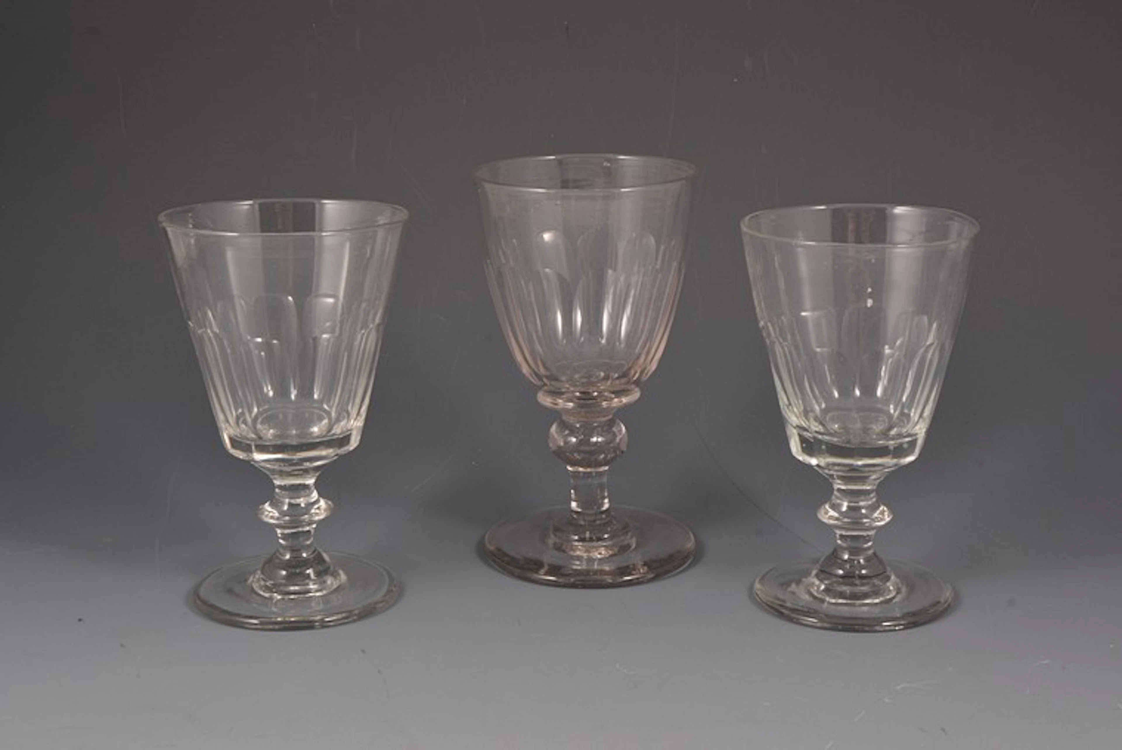 Matched set of six cut glass pedestal drinking glasses.