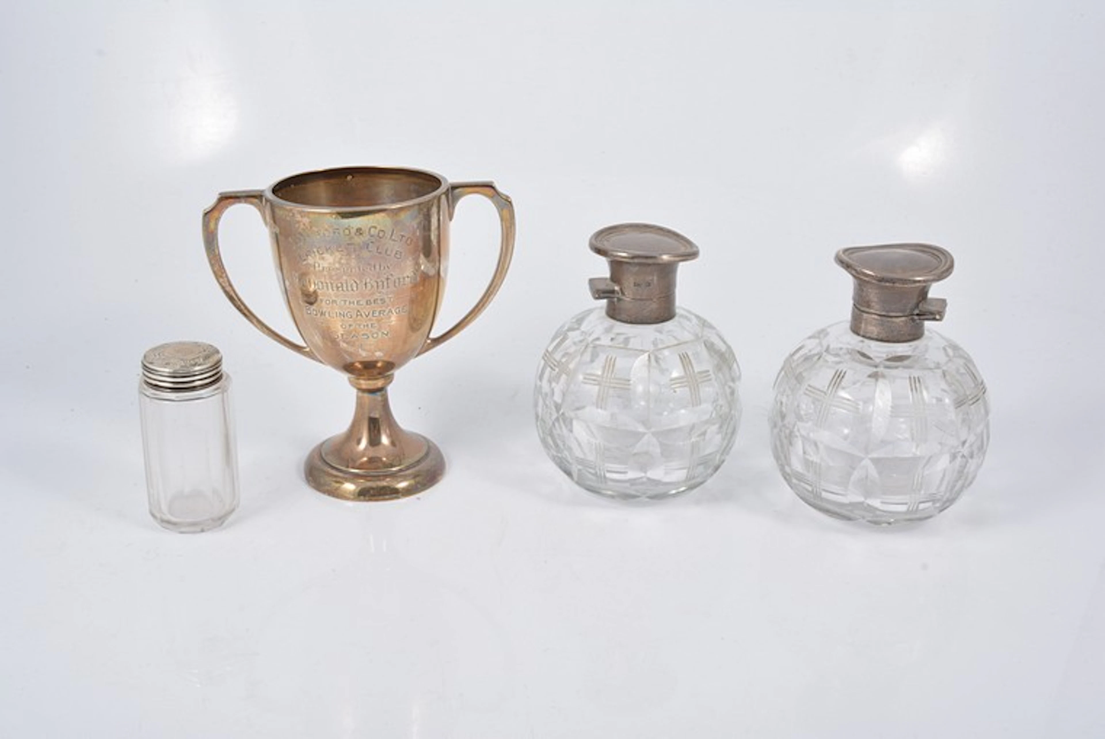 A silver twin handled engraved cricket trophy