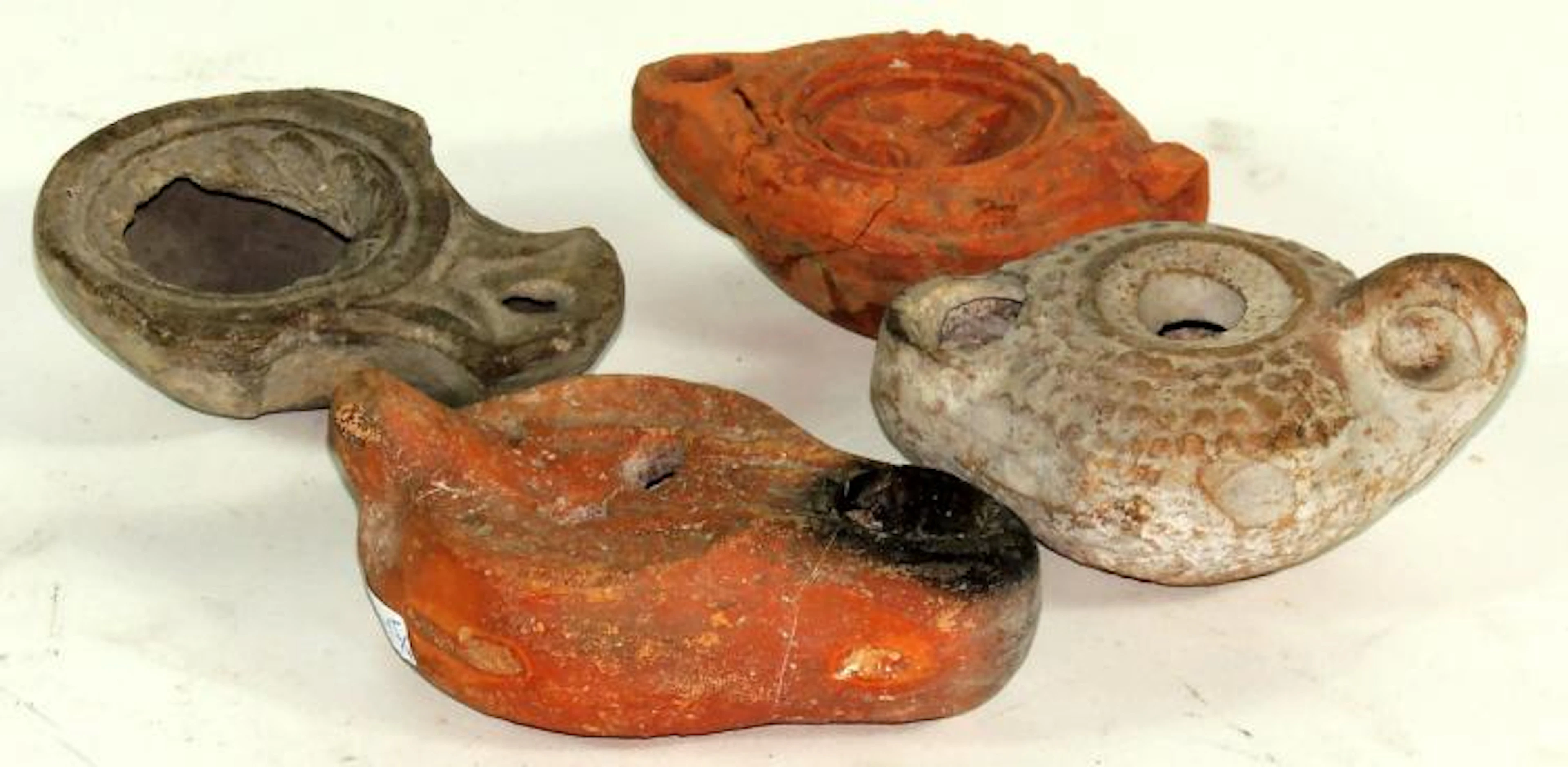 FOUR ROMAN TERRACOTTA OIL LAMPS