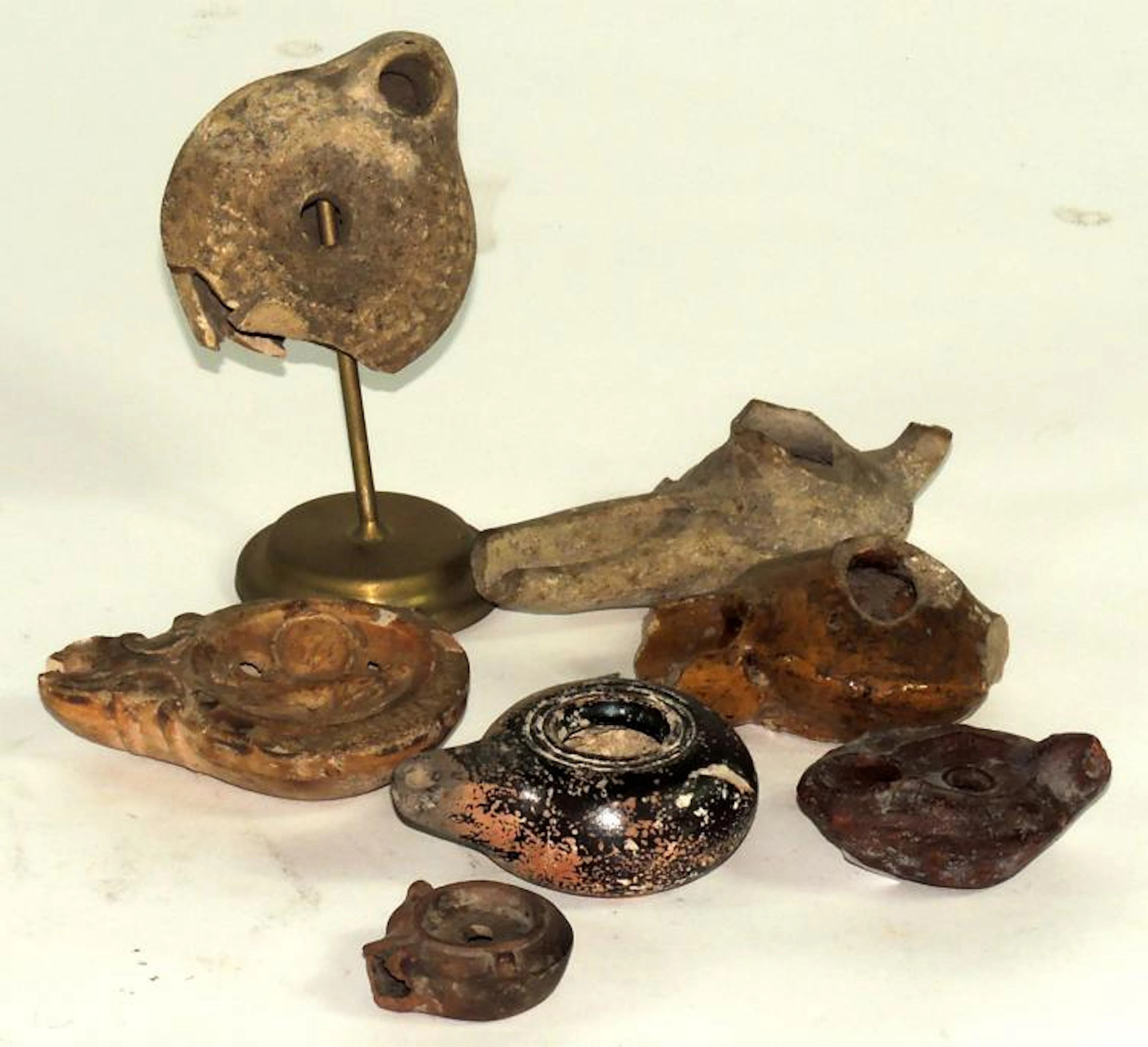 TWO ISLAMIC AND FIVE ROMAN OIL LAMPS