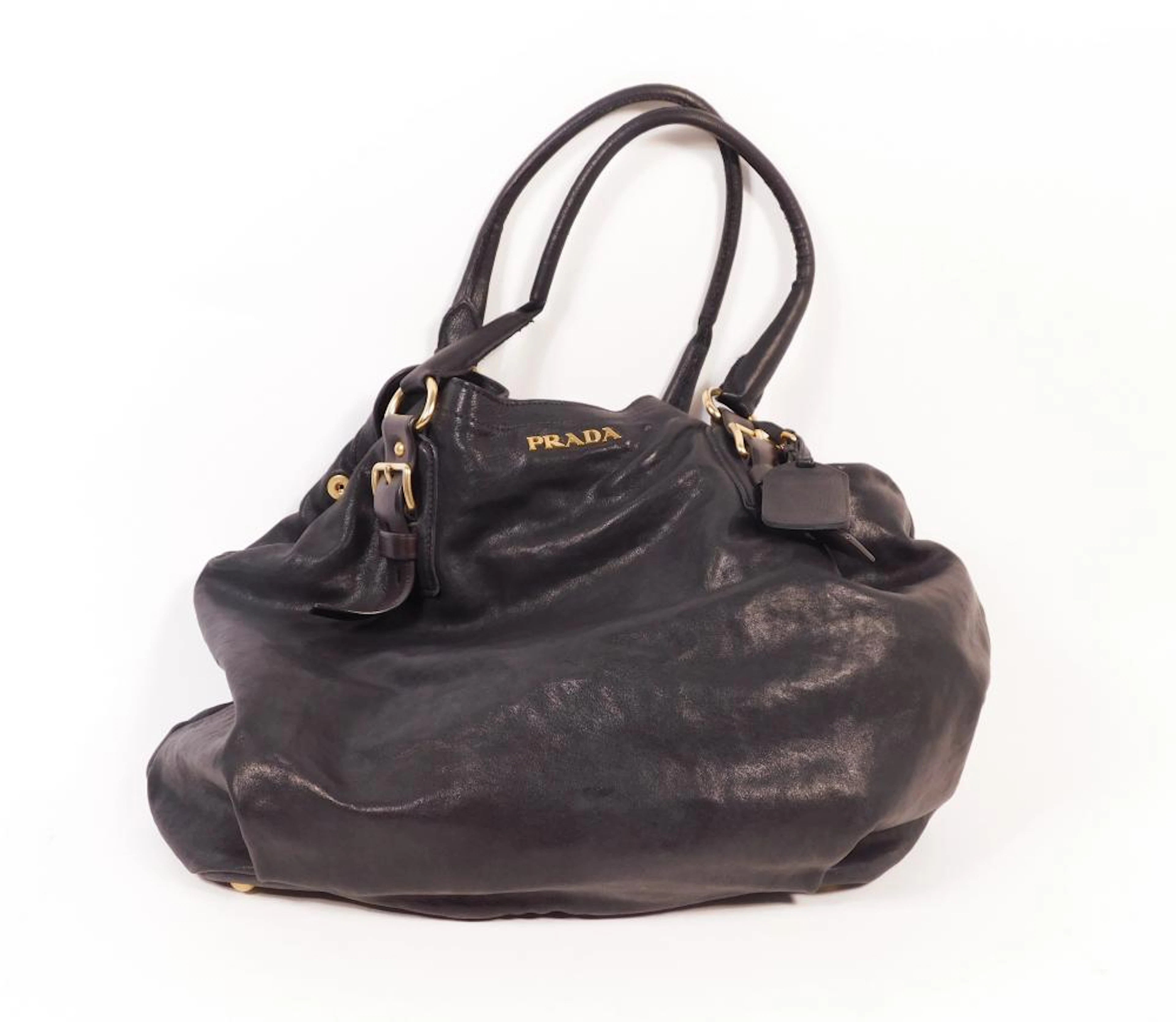 PRADA. BOLSO de piel azul marino con detalles de hebillas en metal dorado