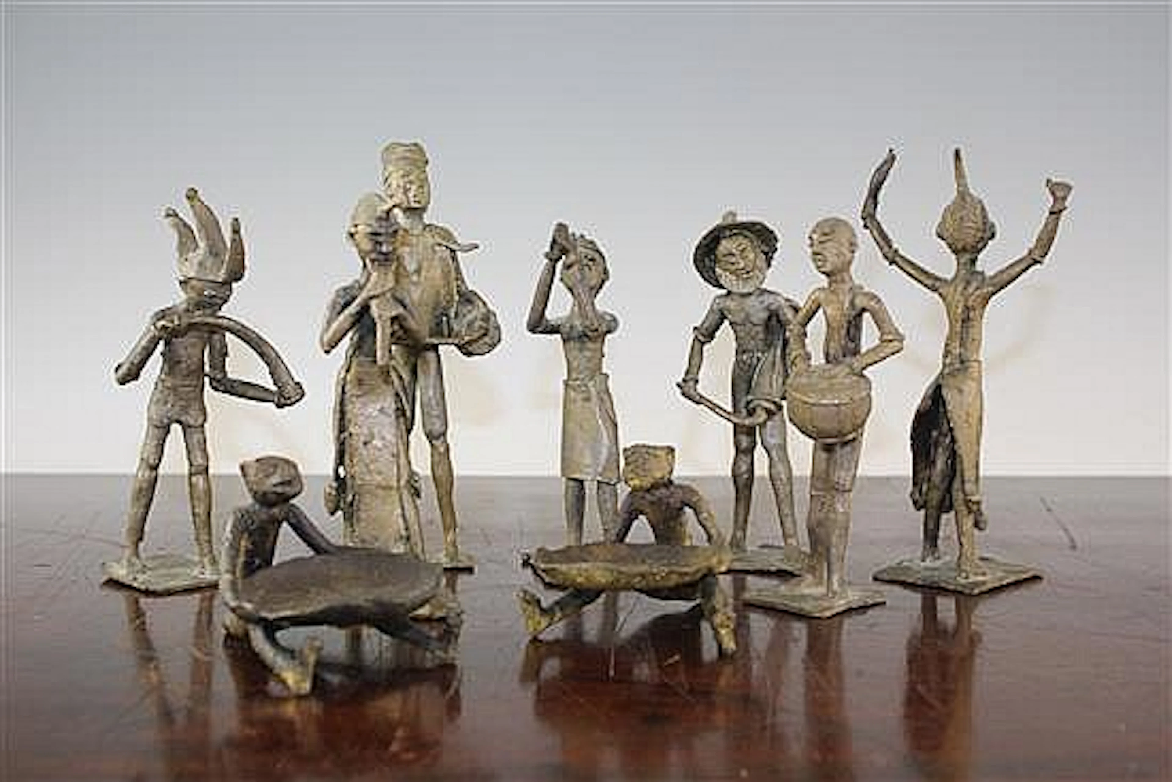 A collection of nine African bronze figures