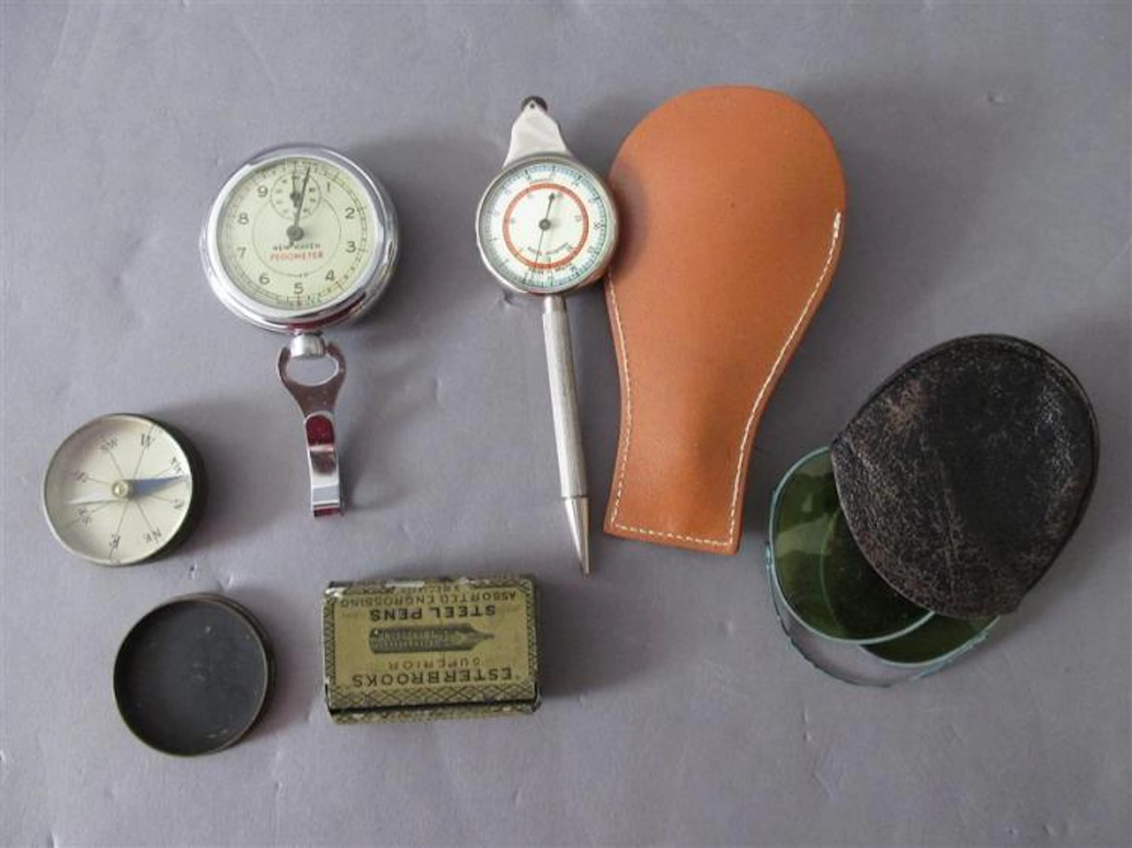 Collection of vintage items: New Haven Pedometer, two compasses one with Nautical Miles recalculator, Easterbrooks steel pens in tol...